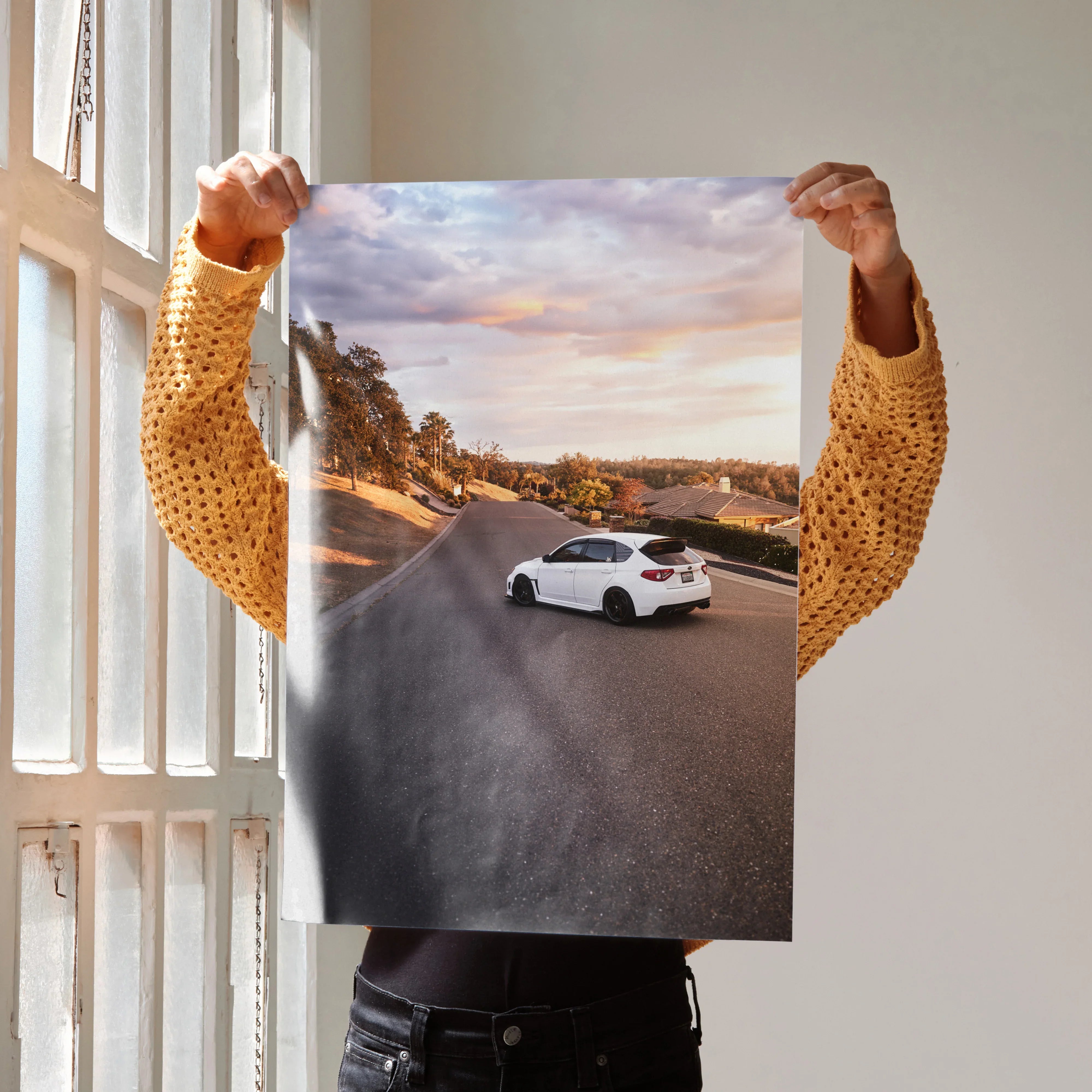 Poster of white Subaru WRX STI on winding road at sunset, iconic automotive wall art.