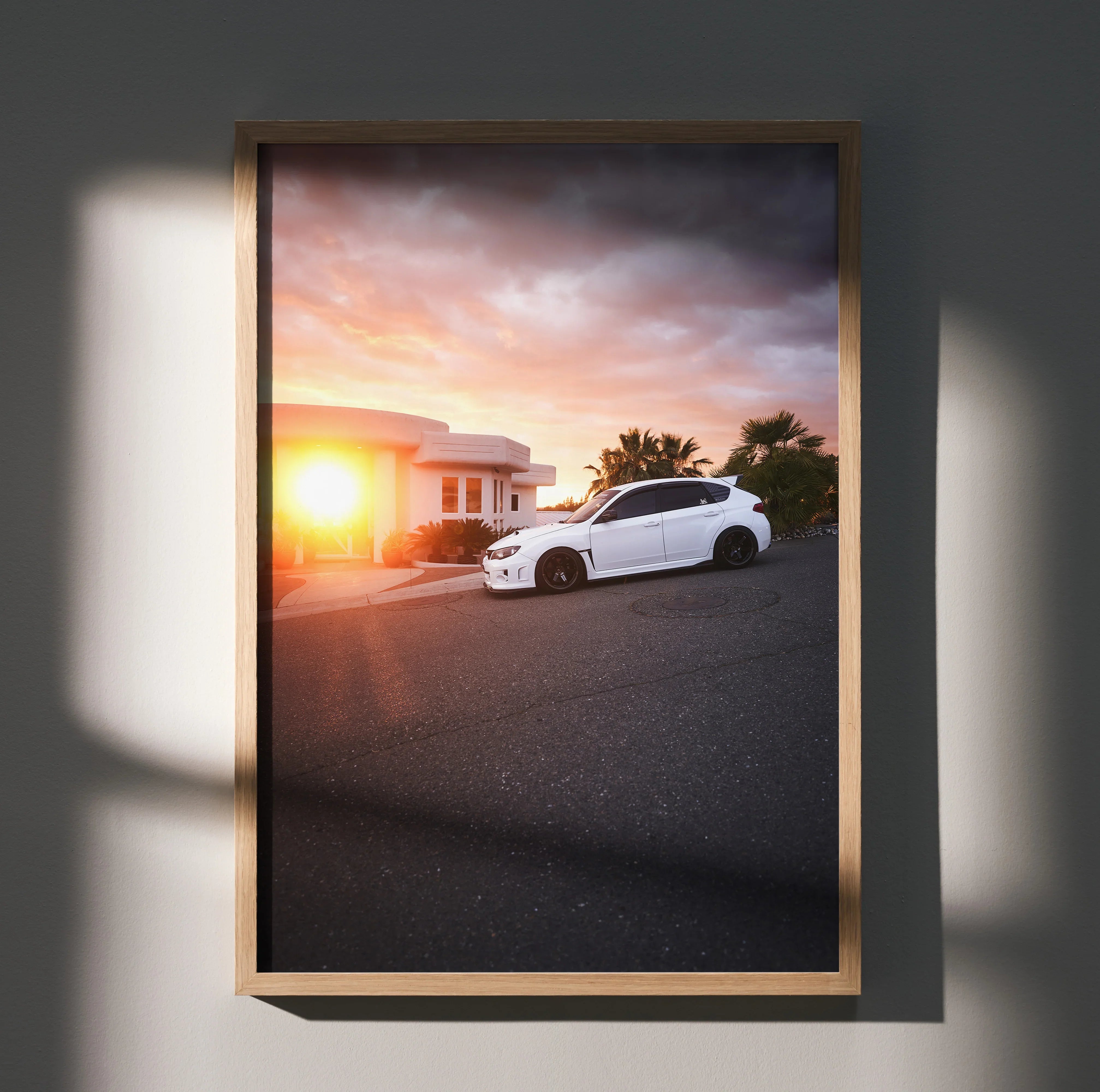 Subaru WRX STI poster with sunset background and white car on street wall art.