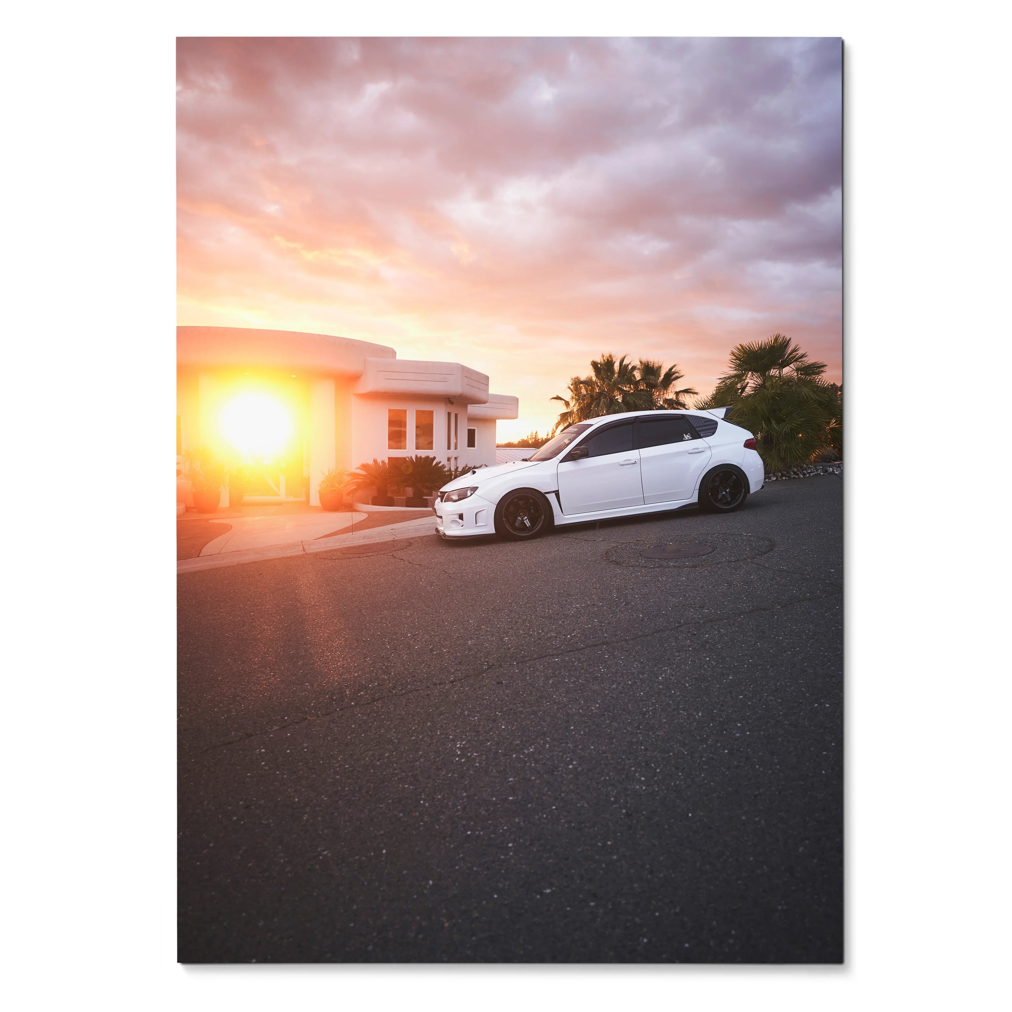 White Subaru WRX STI parked on street at sunset with vibrant sky poster wall art.