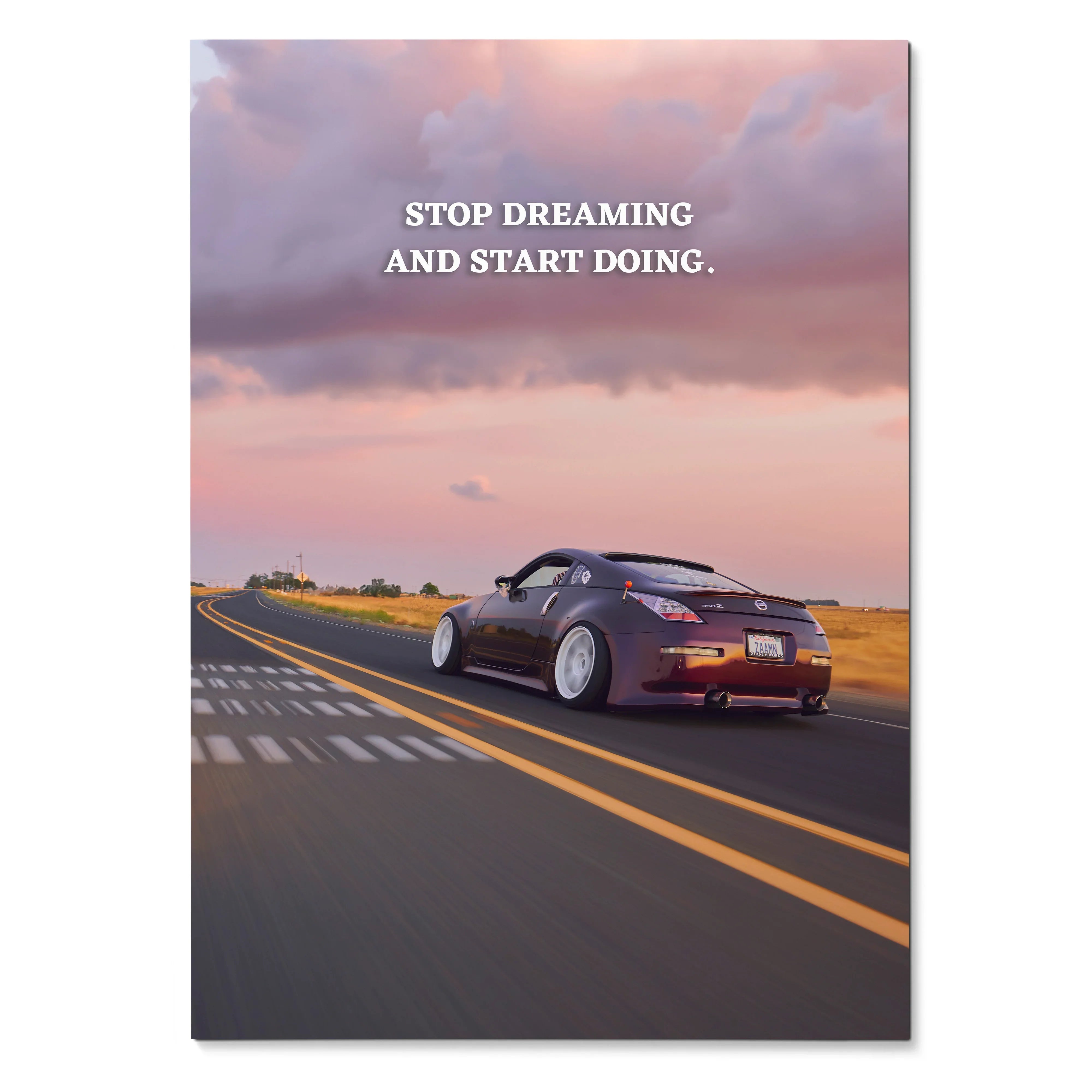 Motivational poster wall art with a black Nissan 350z driving on road at sunset and quote "Stop dreaming and start doing.".