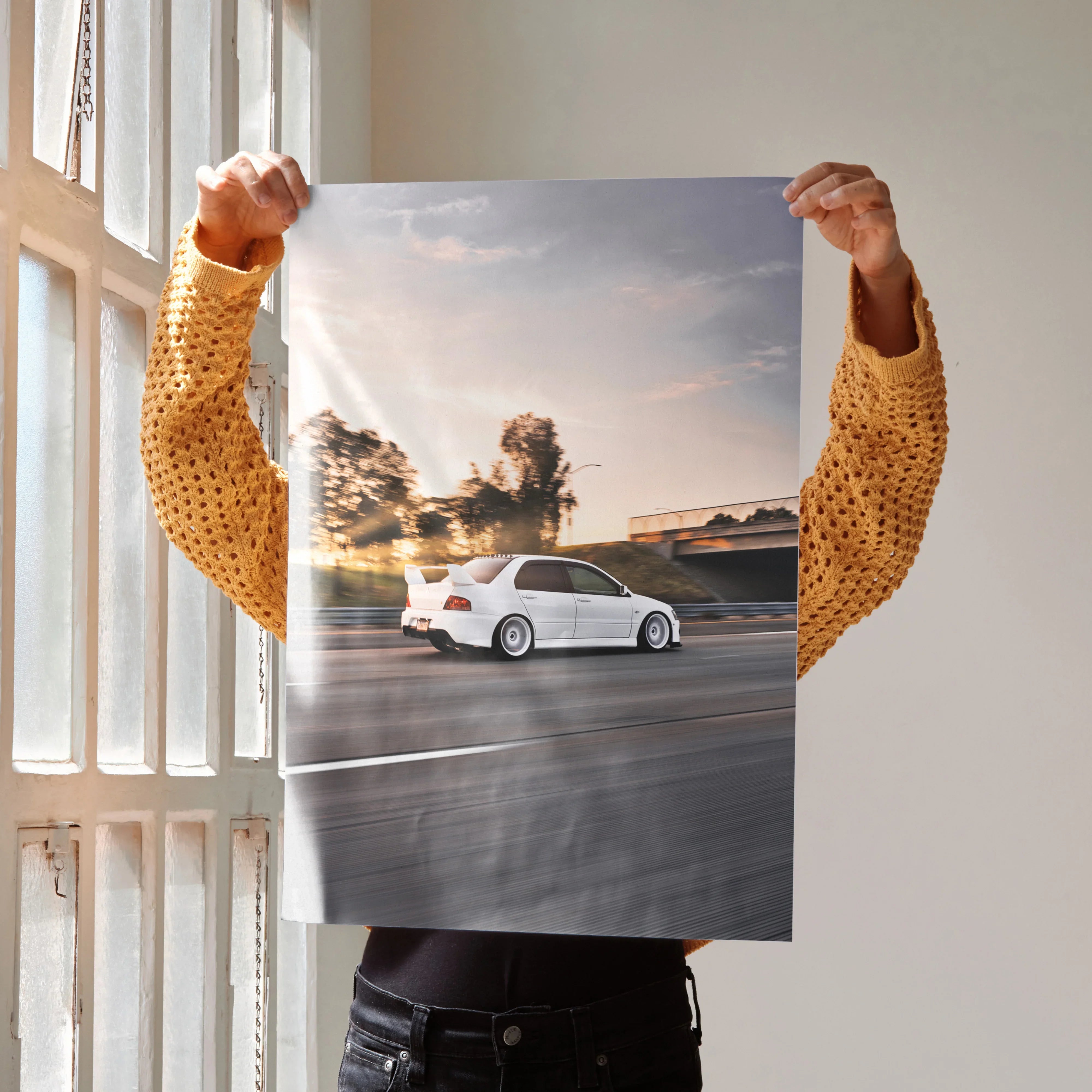 Poster of white Mitsubishi Evo 8 driving on highway at sunset, automotive wall art.