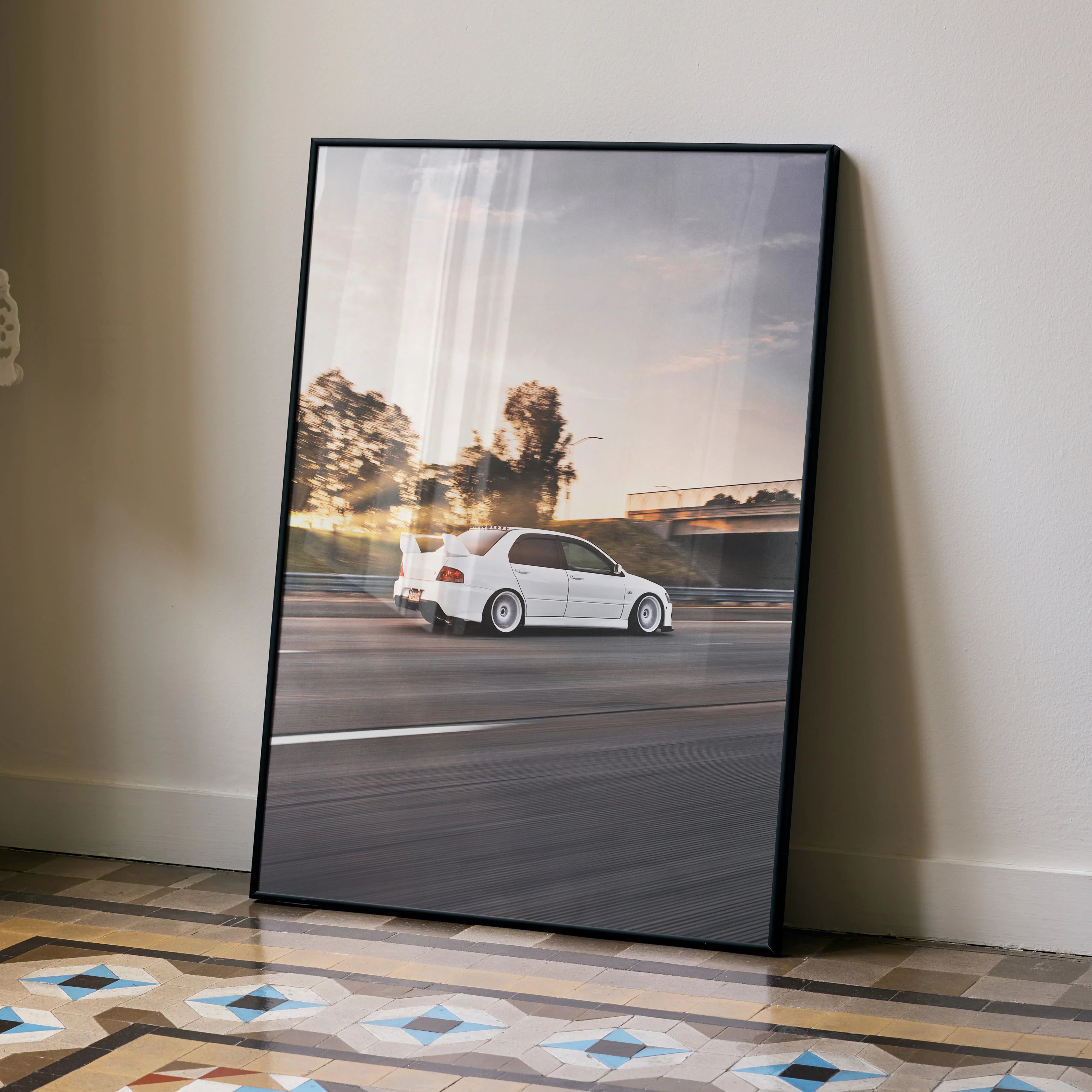 Mitsubishi Evo 8 speeding on road at sunset poster wall art in black frame.