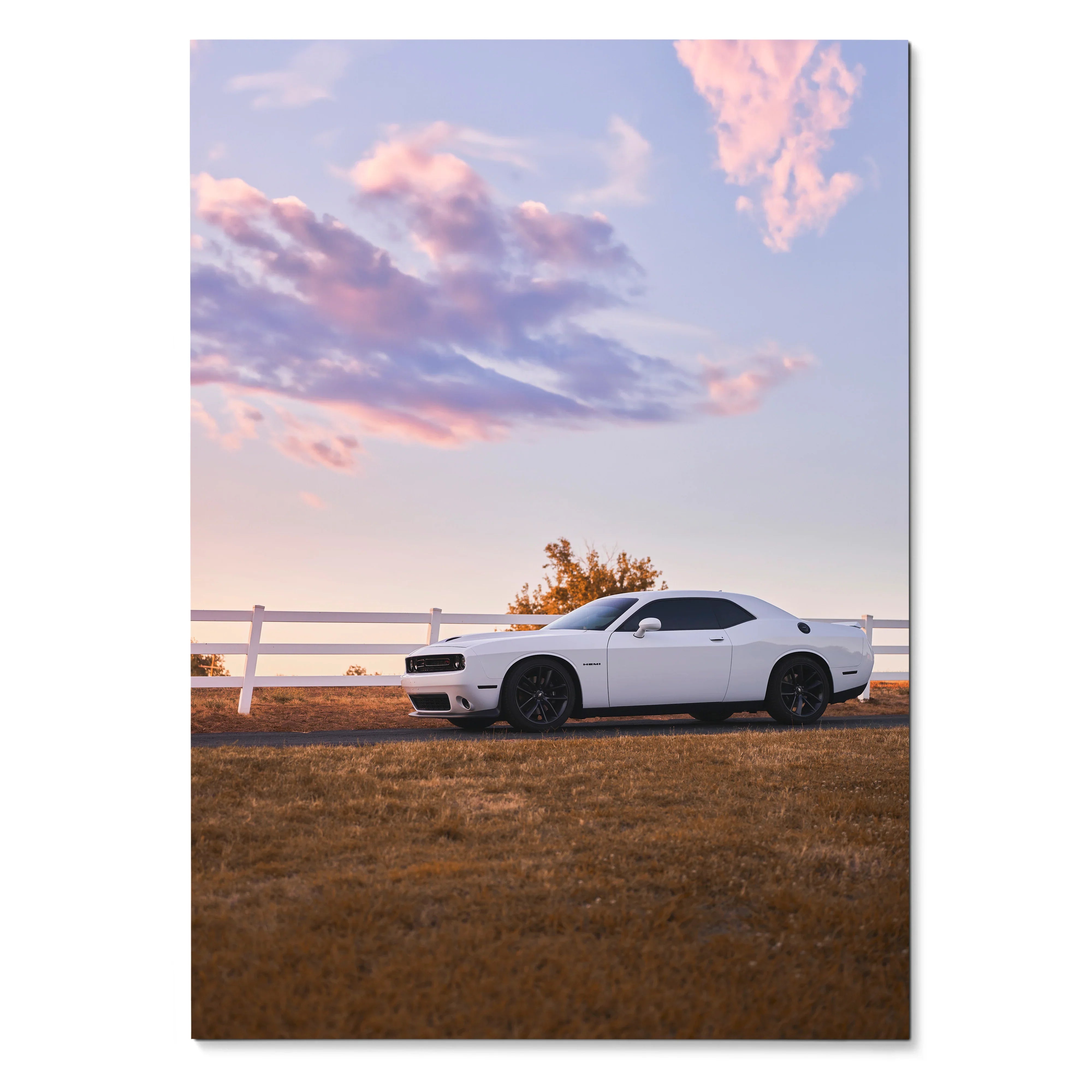 White Dodge Challenger parked beside white fence at sunset poster wall art.