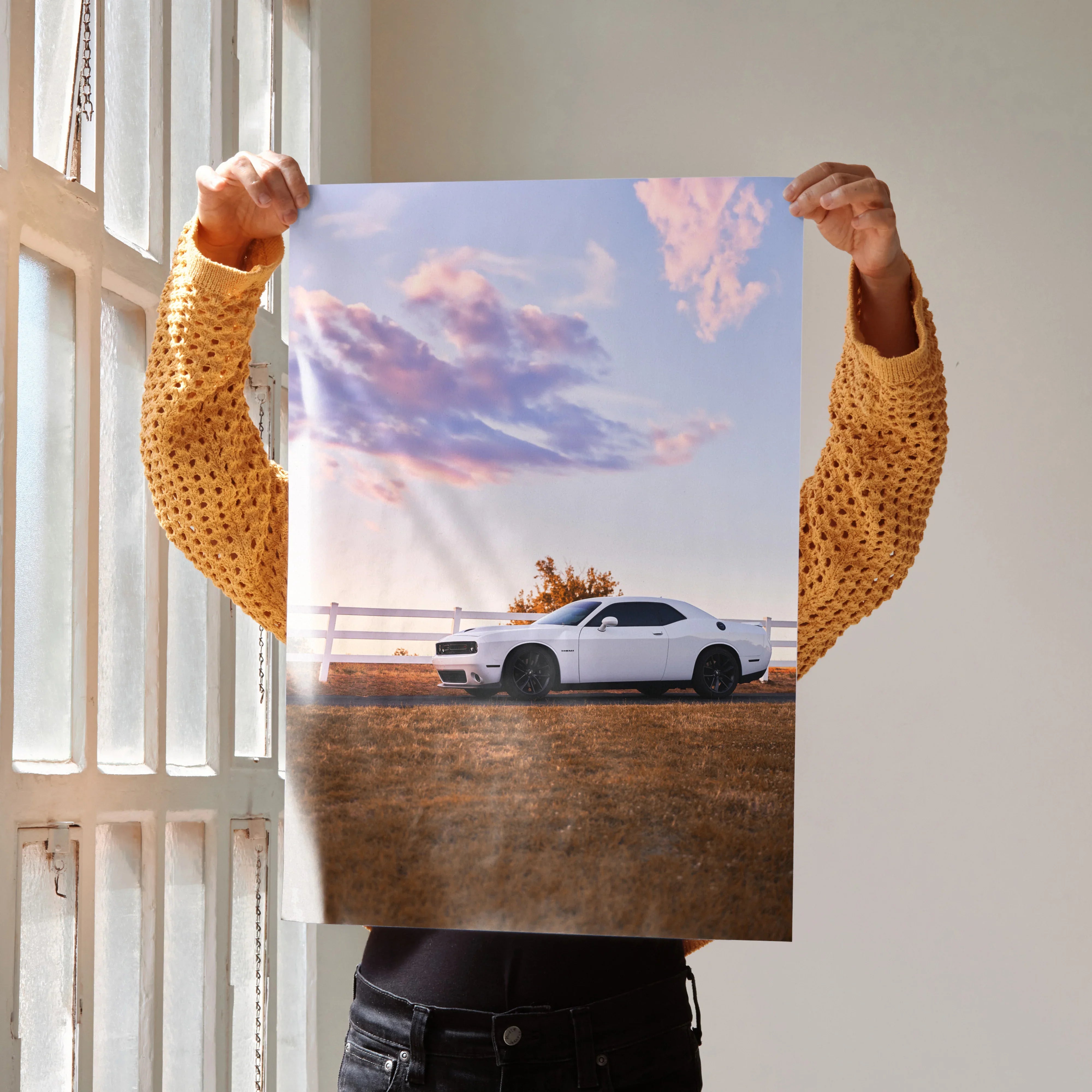Dodge Challenger poster wall art featuring white muscle car against sunset sky with pink clouds.