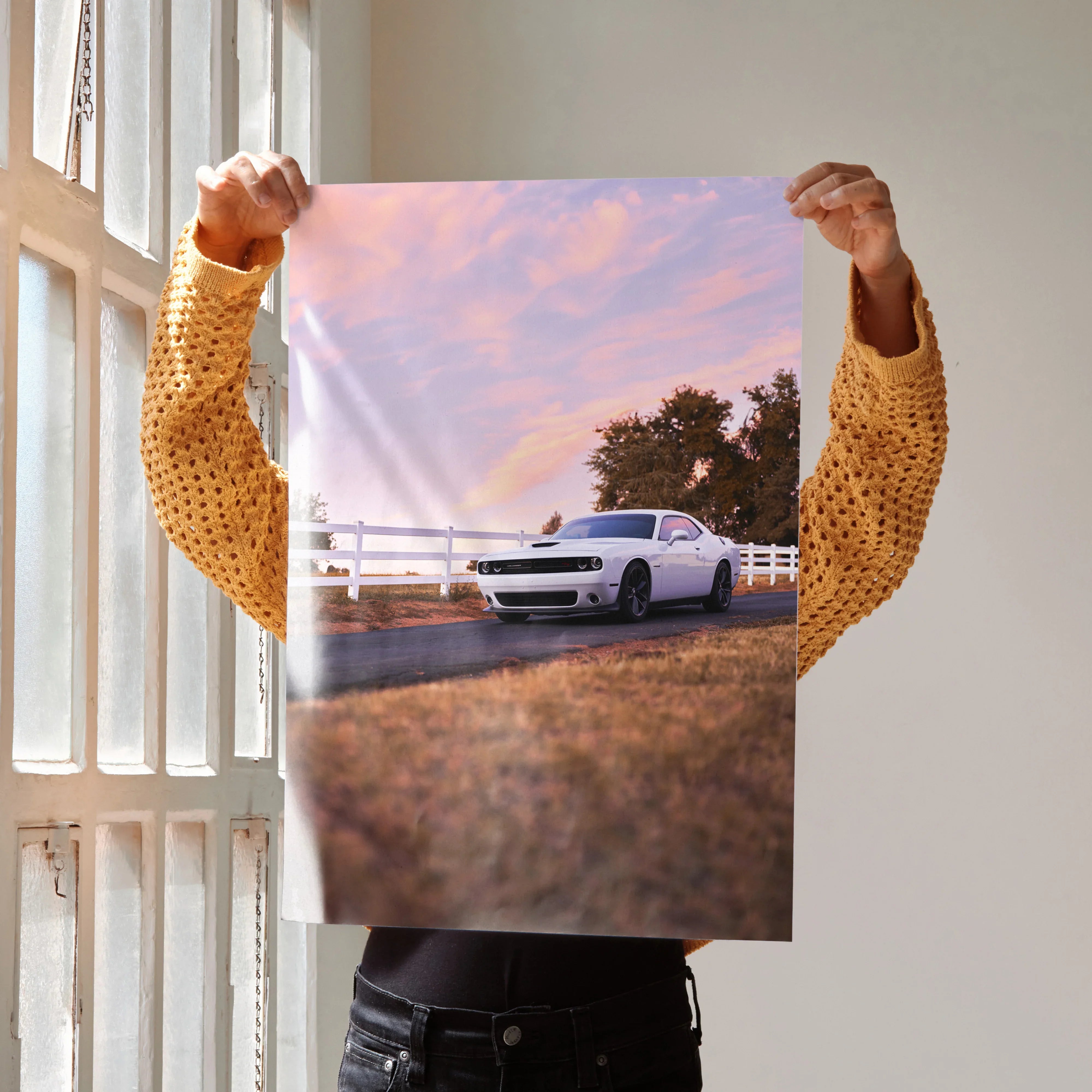 Dodge Challenger parked by white fence at sunset poster wall art.