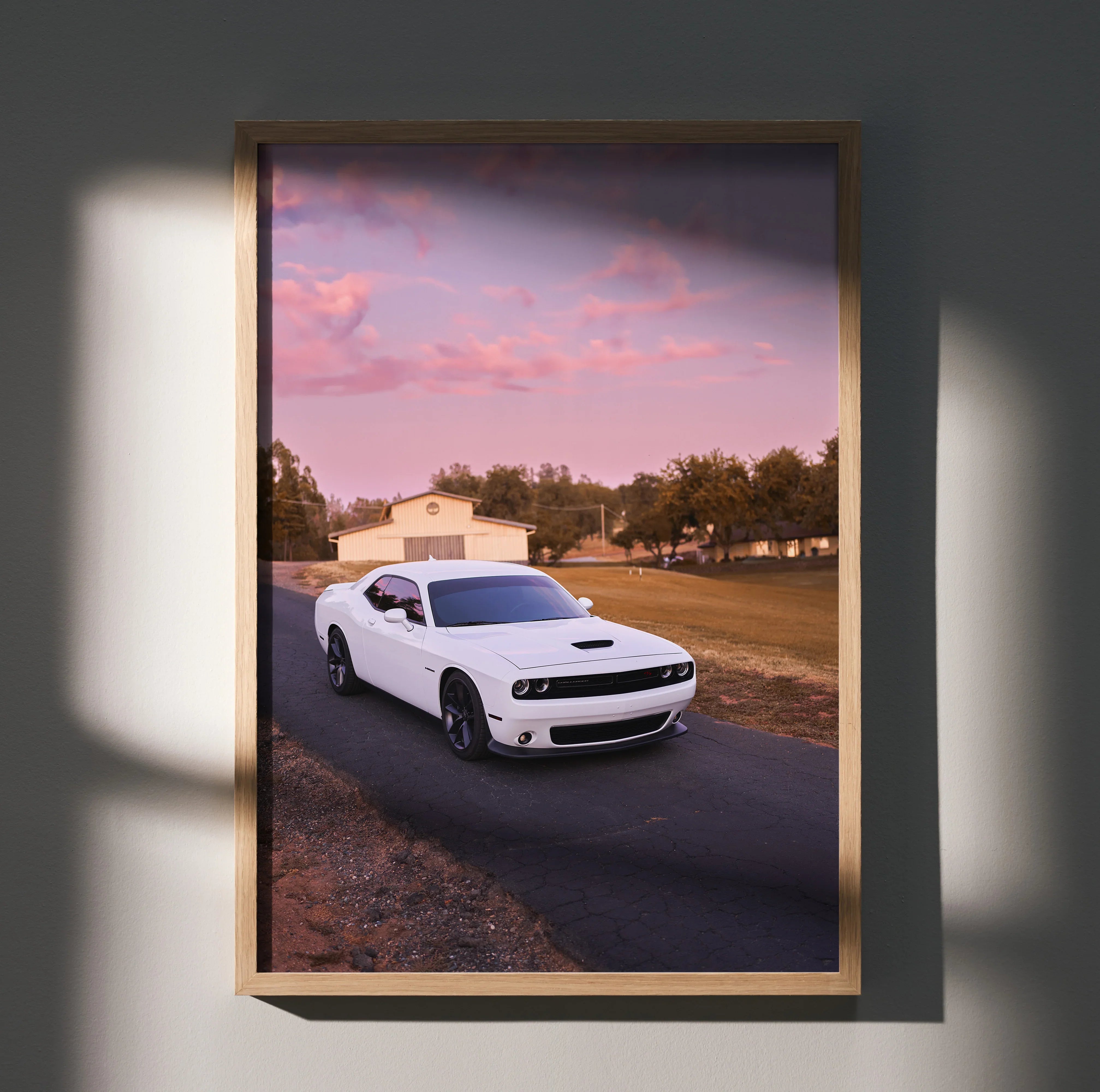 Dodge Challenger poster wall art featuring white muscle car on country road at sunset.