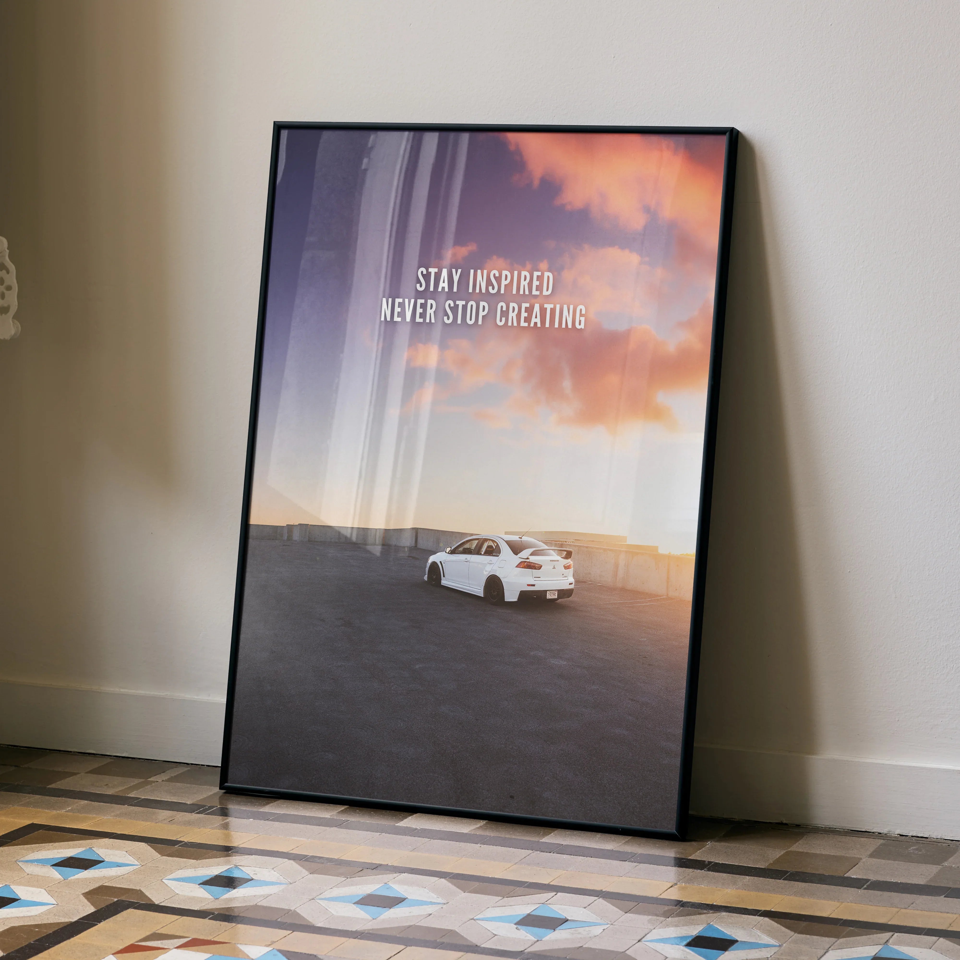 Motivational wall art poster with white Mitsubishi Evo 10 under colorful sunset sky and inspiring text.