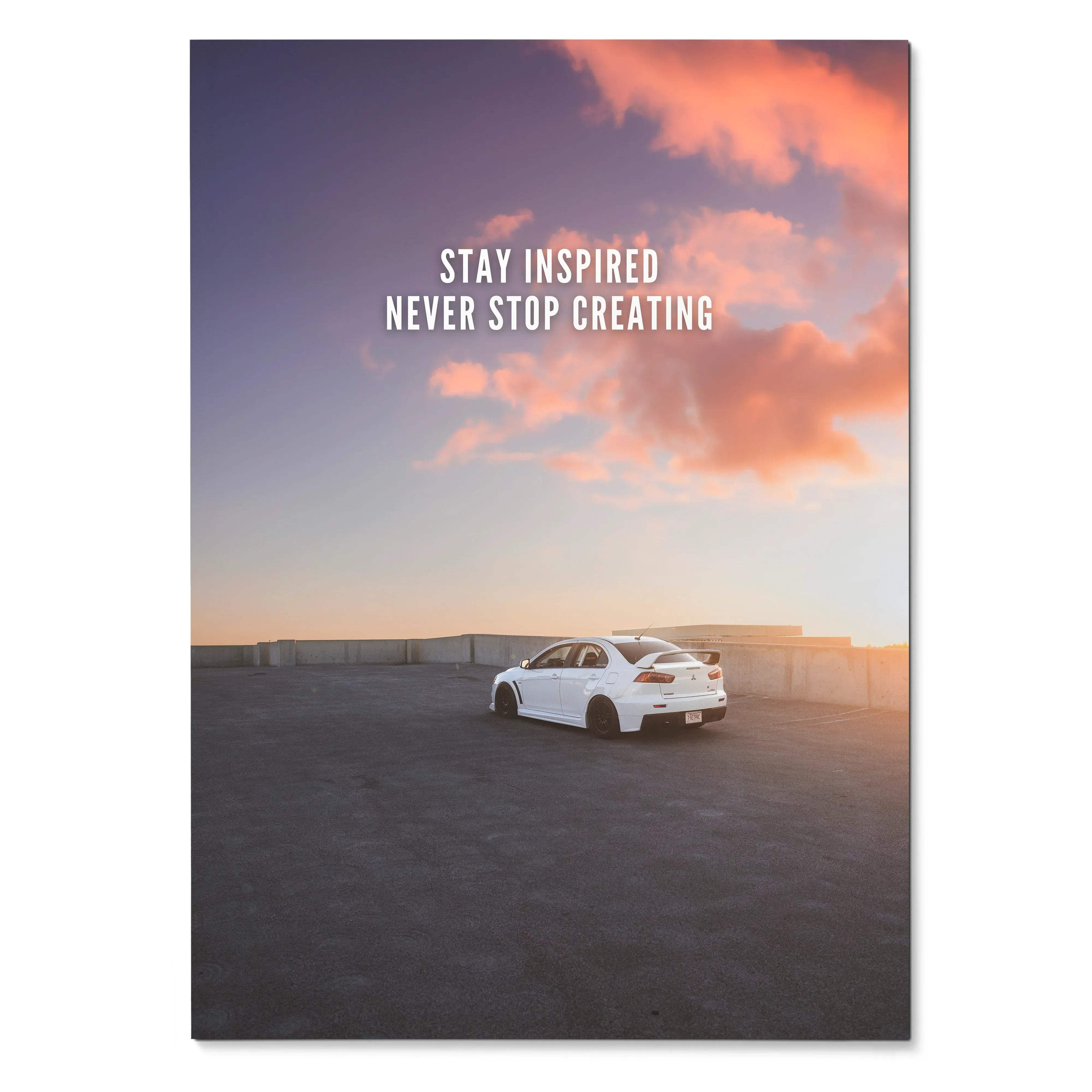 White mitsubishi evo 10 sports sedan parked on rooftop under vibrant orange and purple sunset for motivational poster