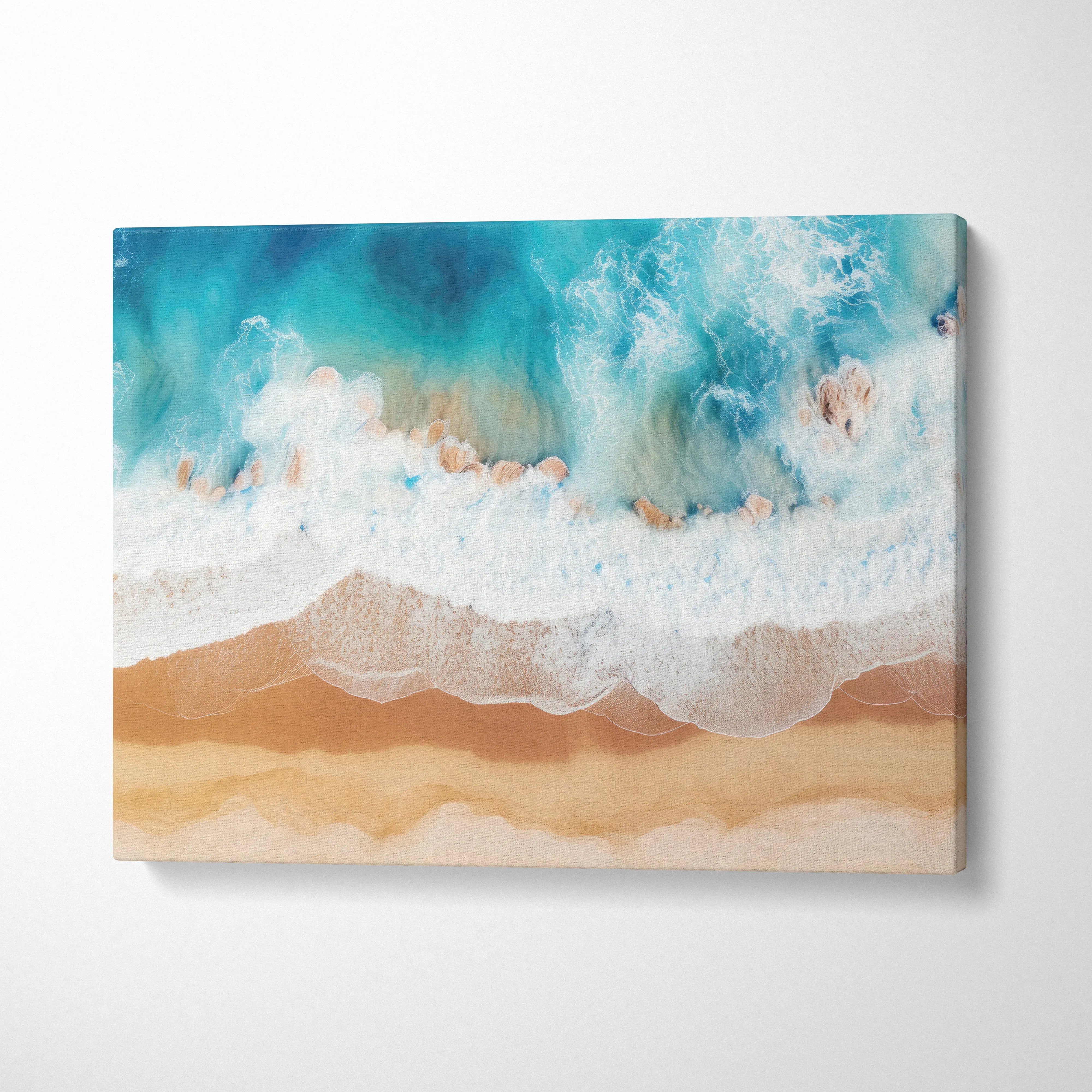 Canvas wall art featuring a tranquil ocean coastline with blue-green waves gently crashing onto sandy beige shore.