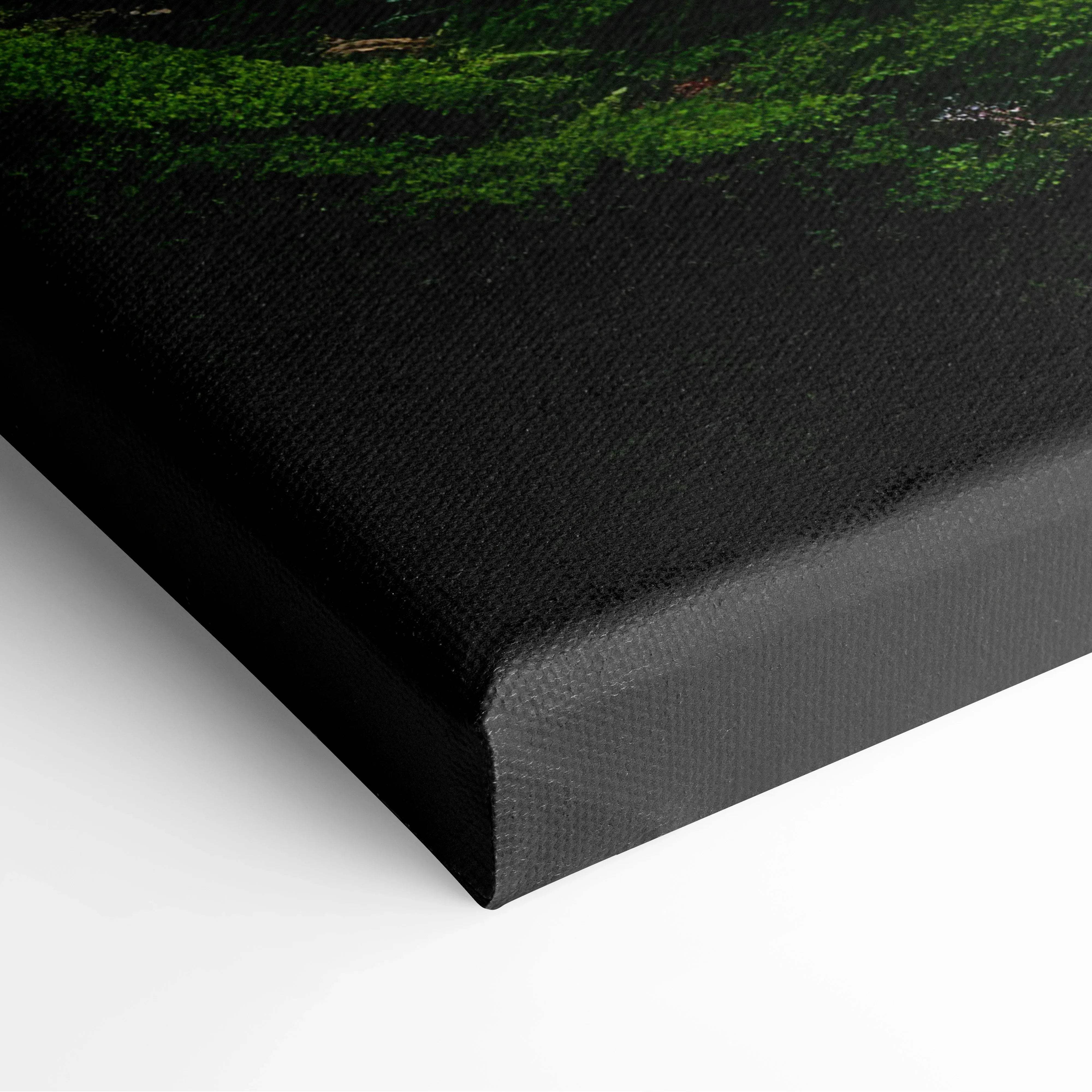 Black canvas print with textured surface featuring a vibrant green tranquil mossy forest landscape scene
