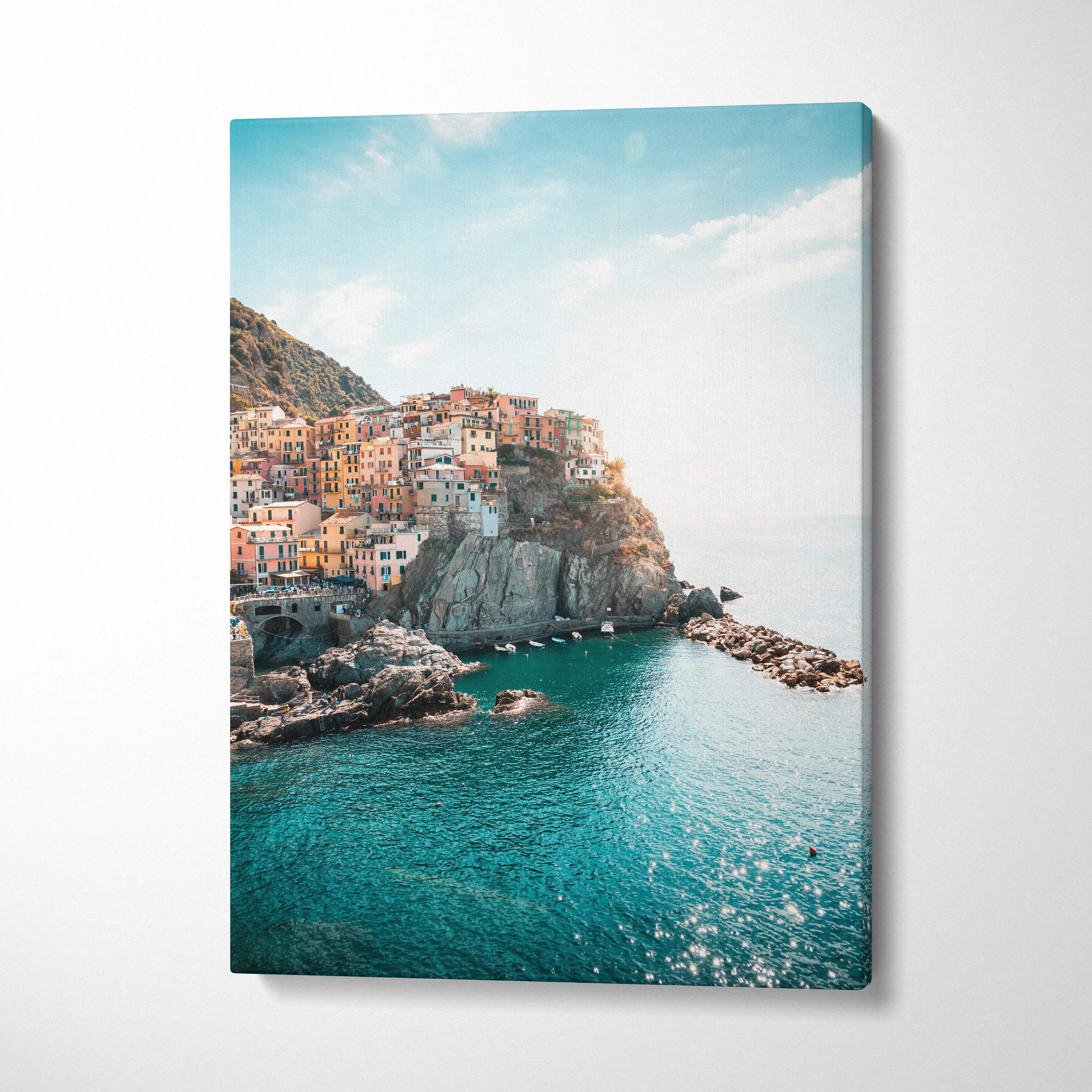 Manarola Italian coastal village canvas wall art with colorful buildings over turquoise sea.