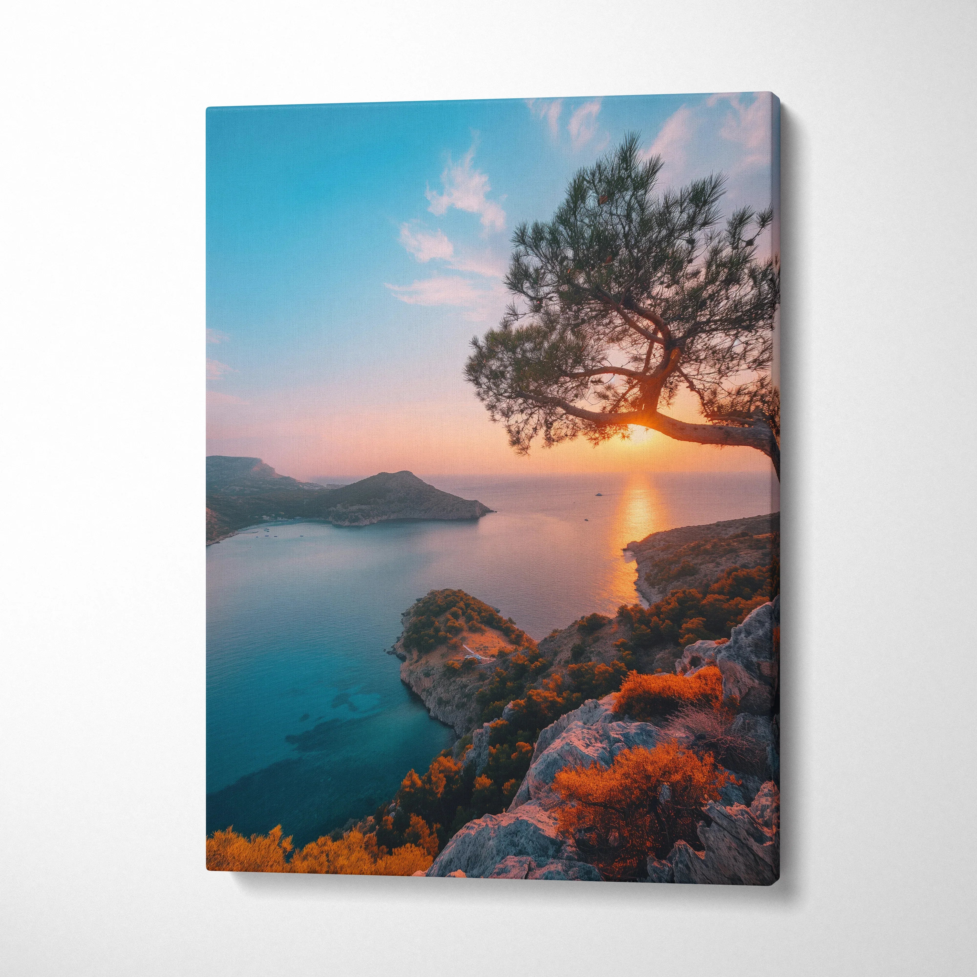 Canvas wall art featuring a serene beach sunset with vibrant orange and blue hues and silhouetted tree on rocky shore.