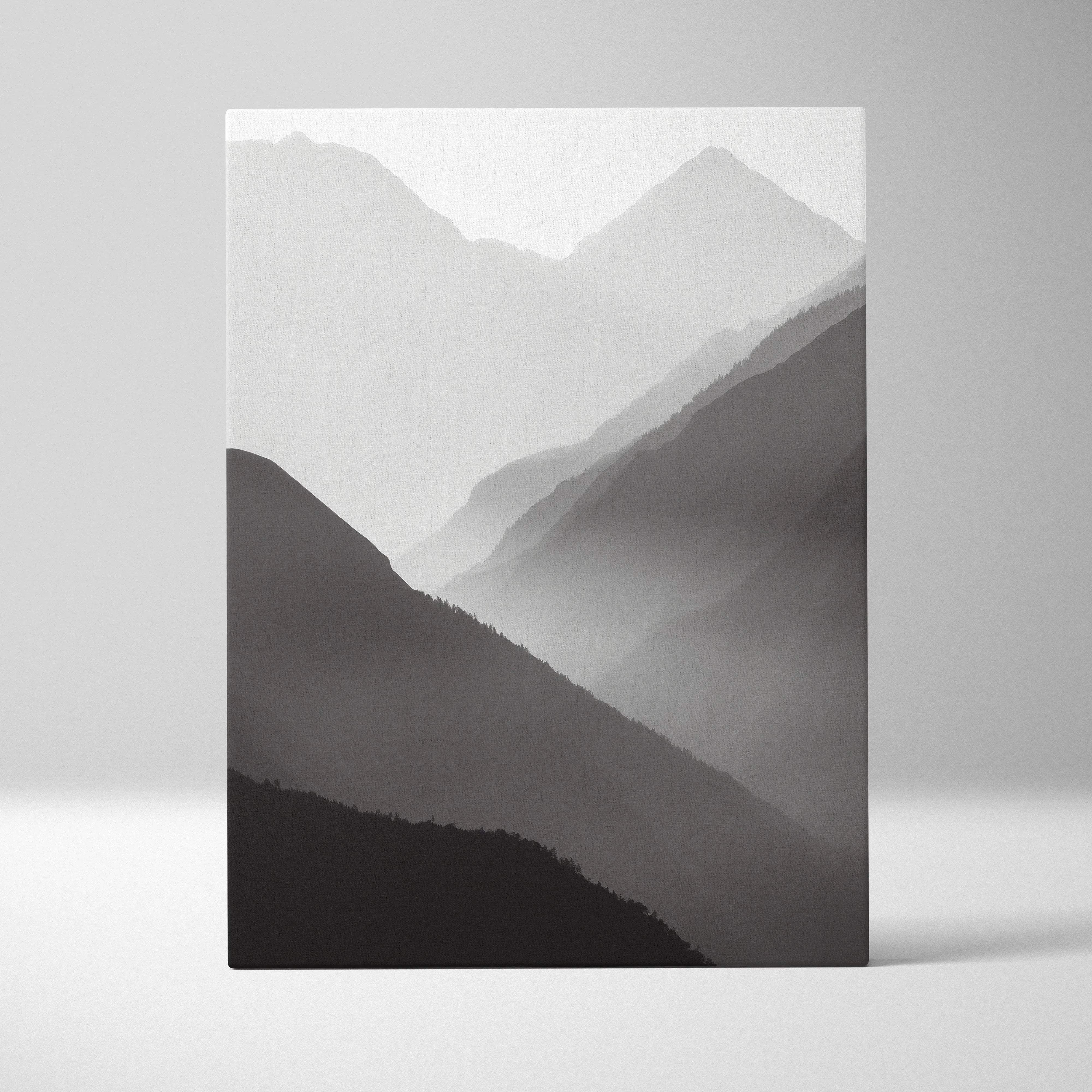 Minimalist black and white mountain landscape canvas print in misty gray tones for serene modern home decor