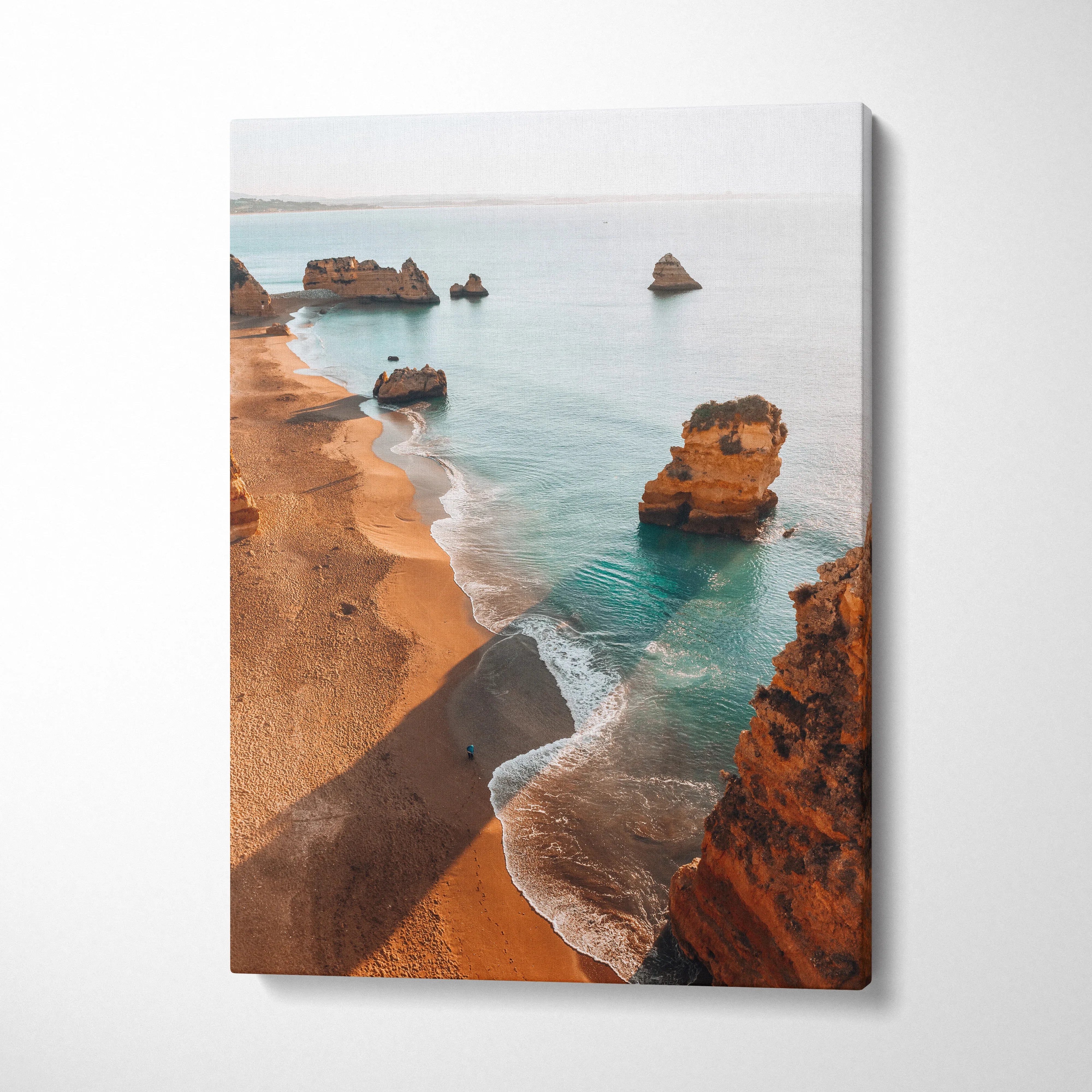 Coastal canvas art featuring golden cliffs and blue ocean waves in warm natural tones.