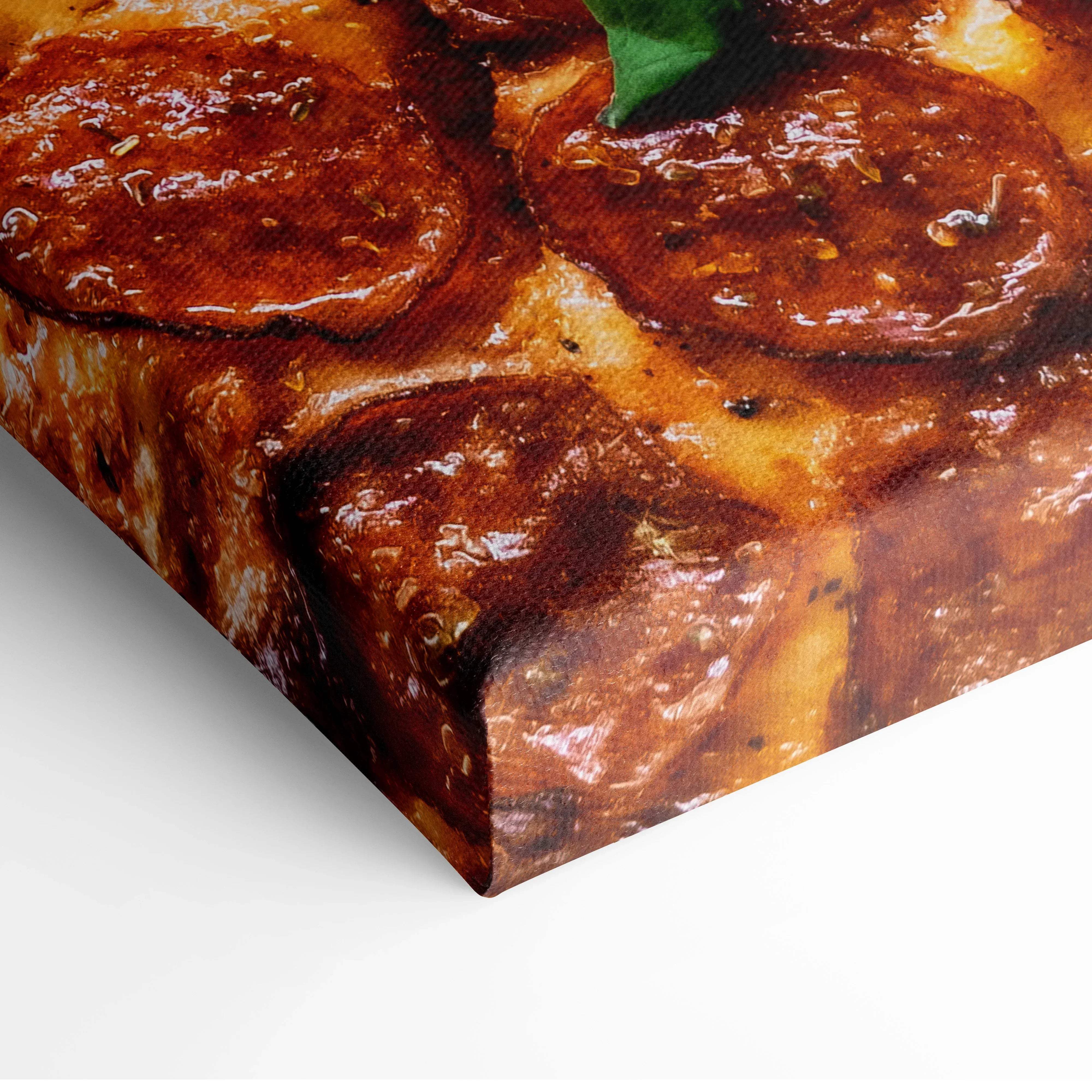 Canvas print of golden-brown glazed pork chops with herbs and green leaf in warm cozy colors for kitchen decor