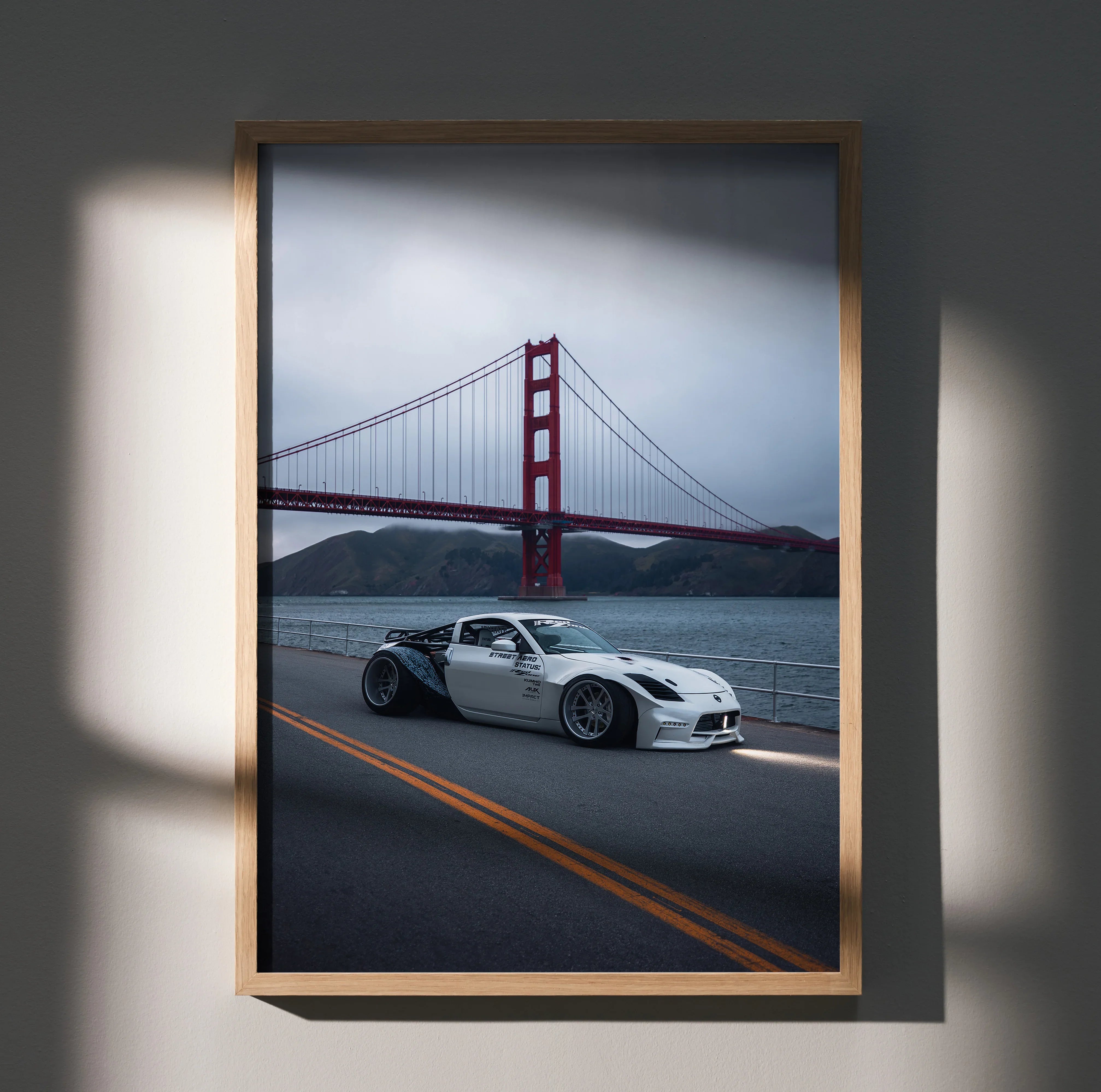 Nissan 350z widebody in front of Golden Gate Bridge poster wall art in wooden frame.