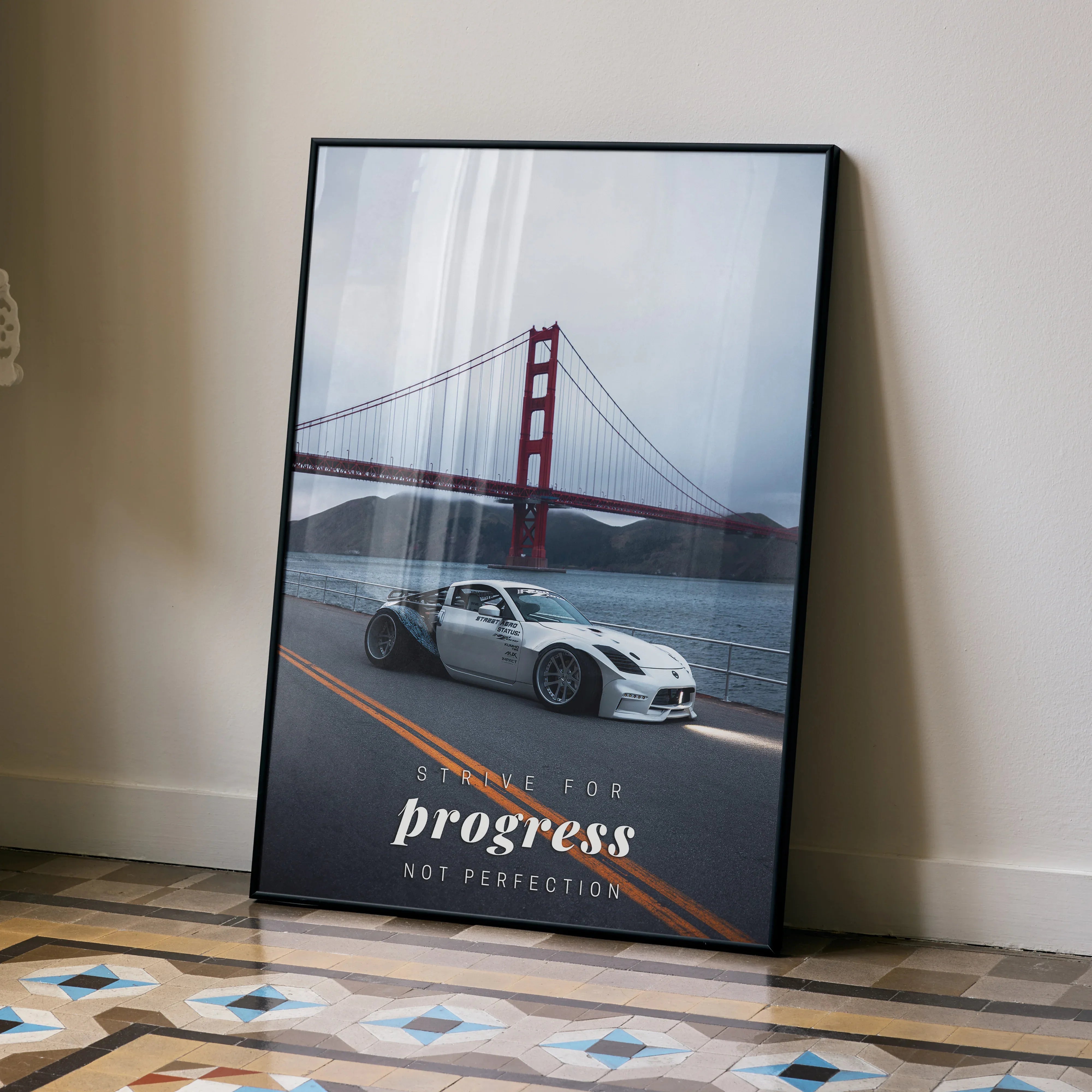 Motivational poster wall art featuring a white Nissan 350z with Golden Gate Bridge and inspiring text "Progress Not.