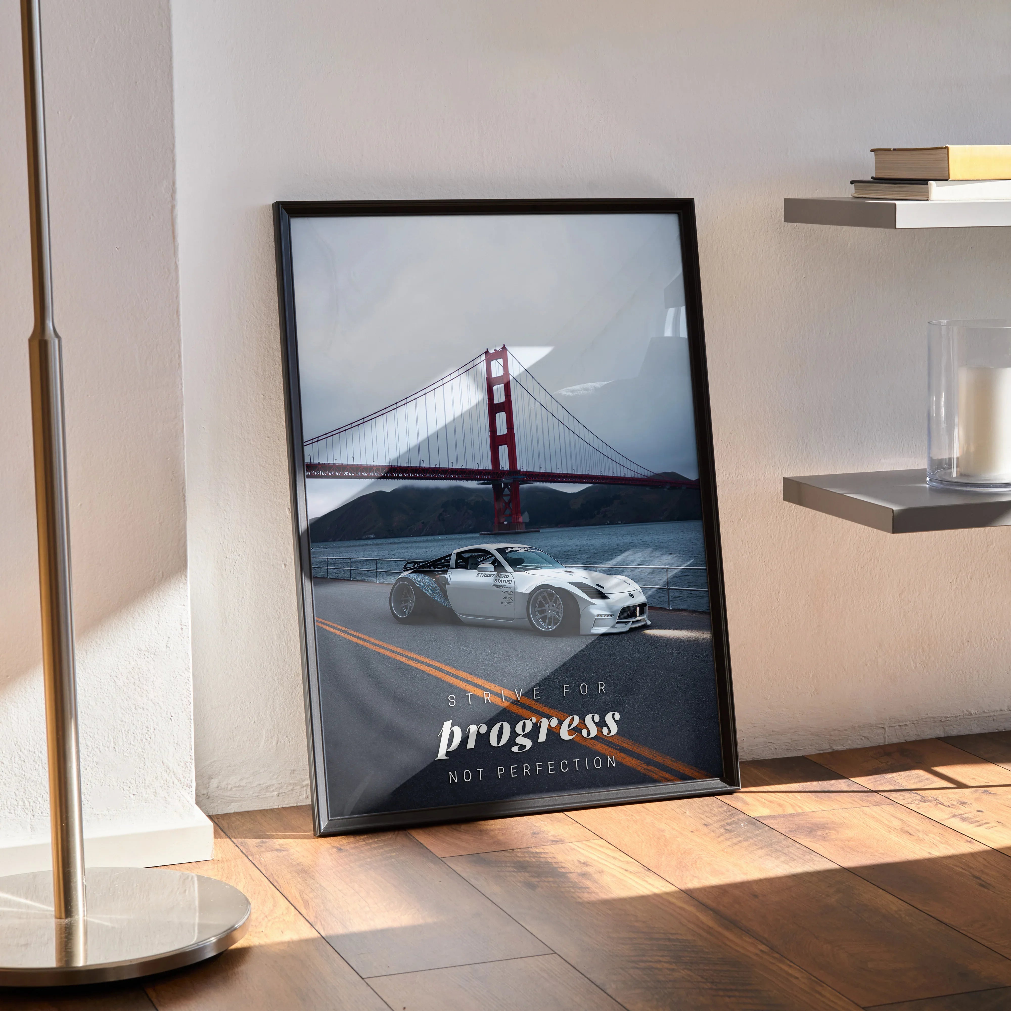 Motivational poster wall art featuring a white Nissan 350z driving on a road with the Golden Gate Bridge and inspiring text.