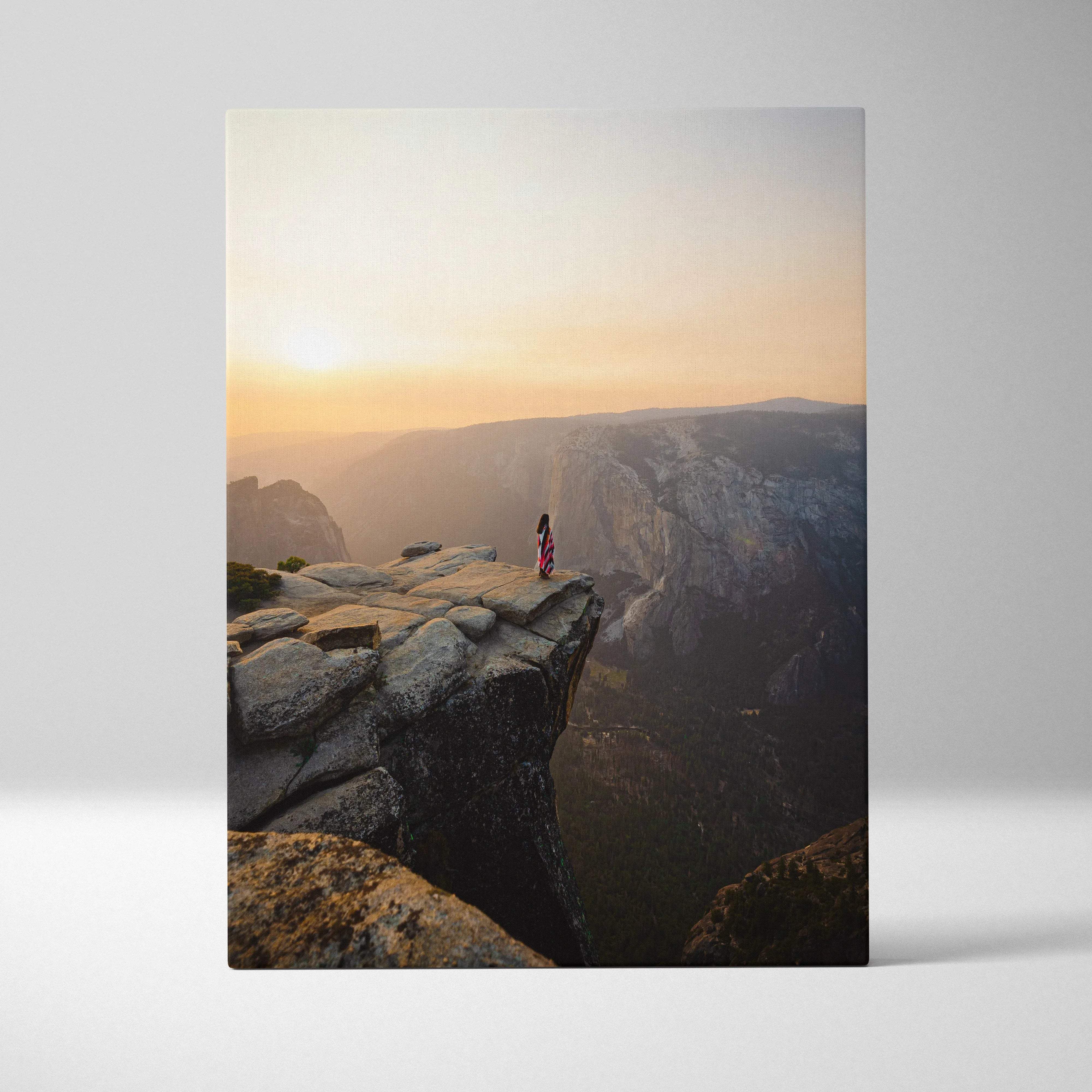 Visionary solitary figure on granite cliff at sunrise over majestic canyon canvas art