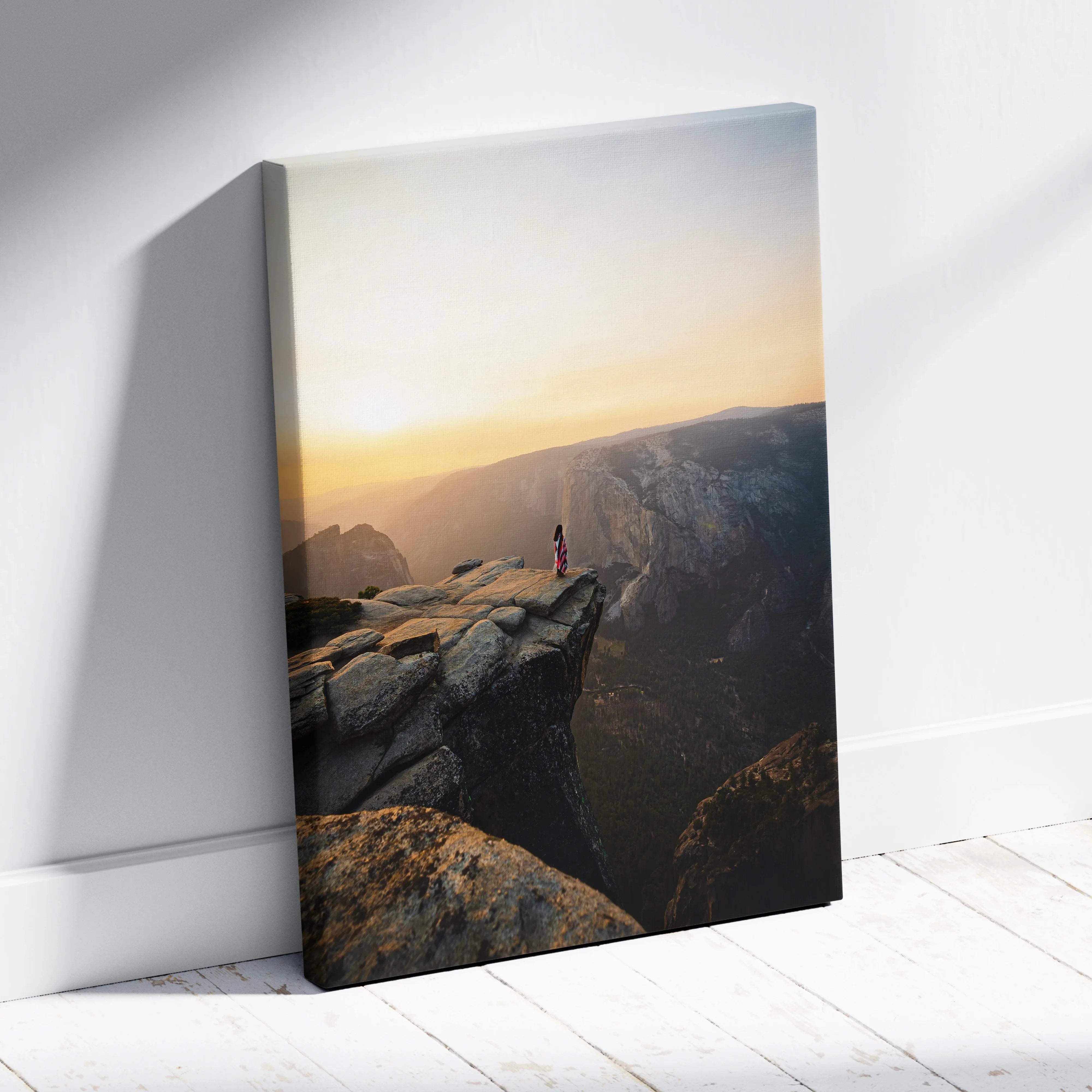Visionary solitary figure on granite cliff at sunrise over canyon canvas art