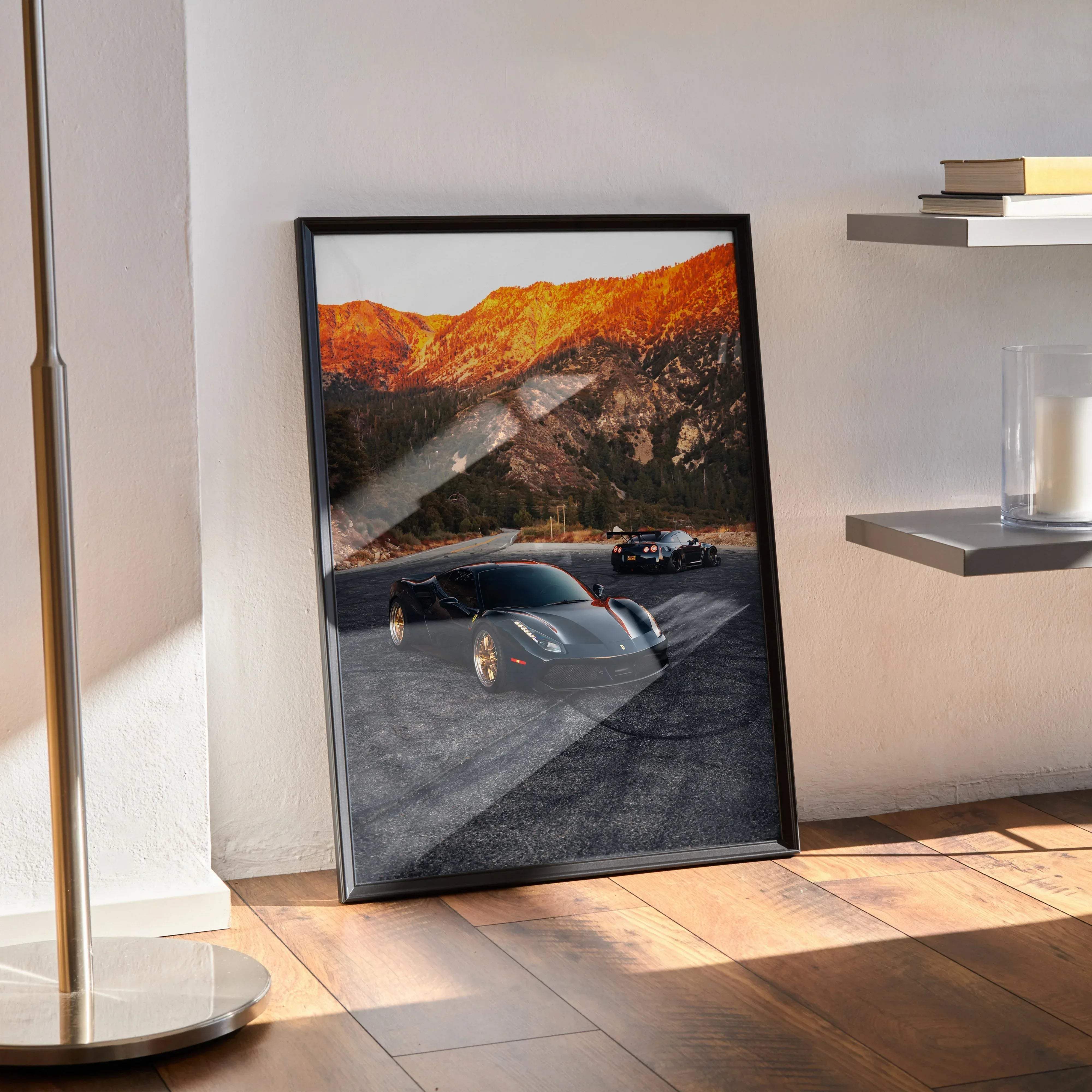 Black-framed poster of ferrari 488 gtb and nissan gtr r35 art print featuring black sports car with gold rims on mountain road