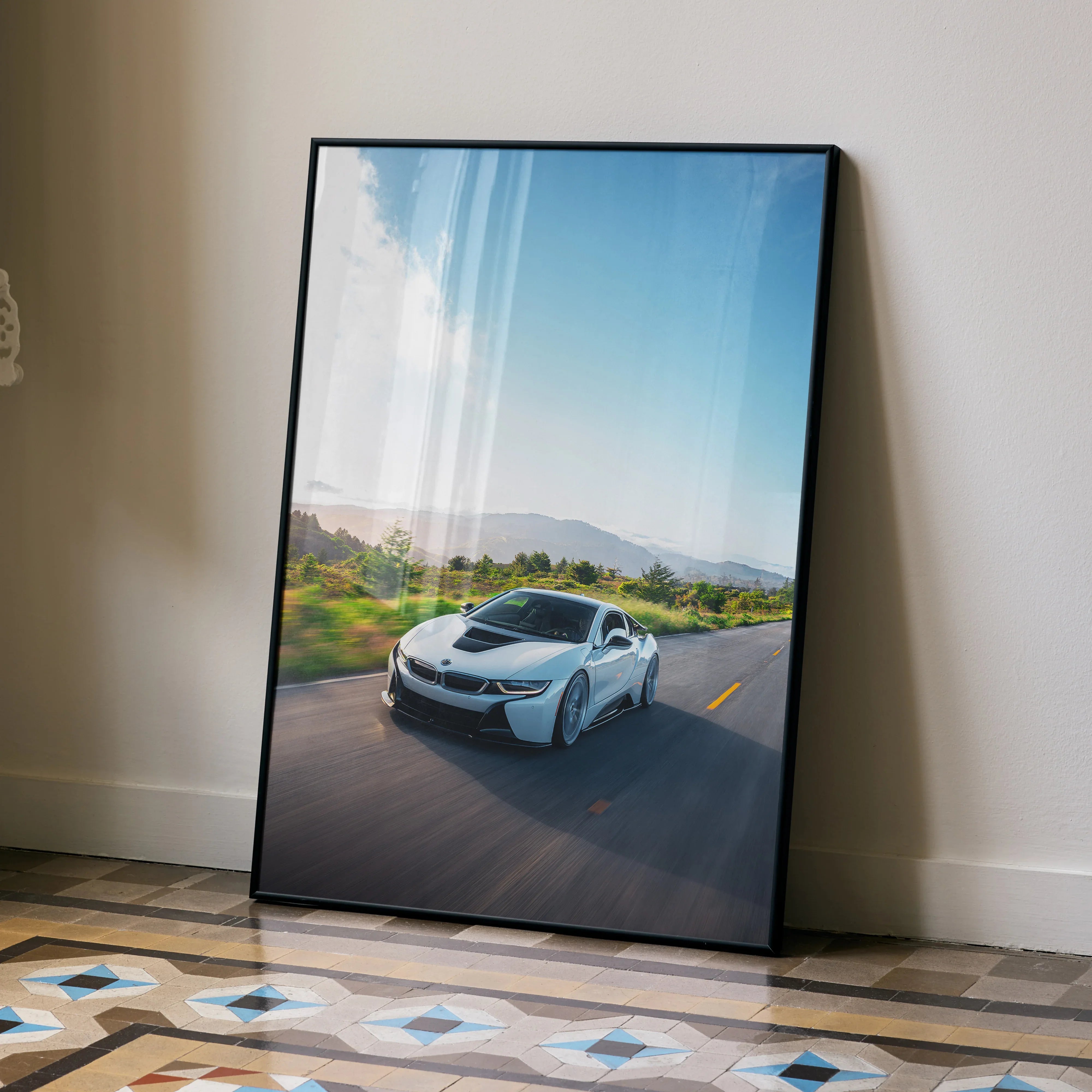 BMW i8 sleek sports car driving on open road landscape poster wall art in black frame.