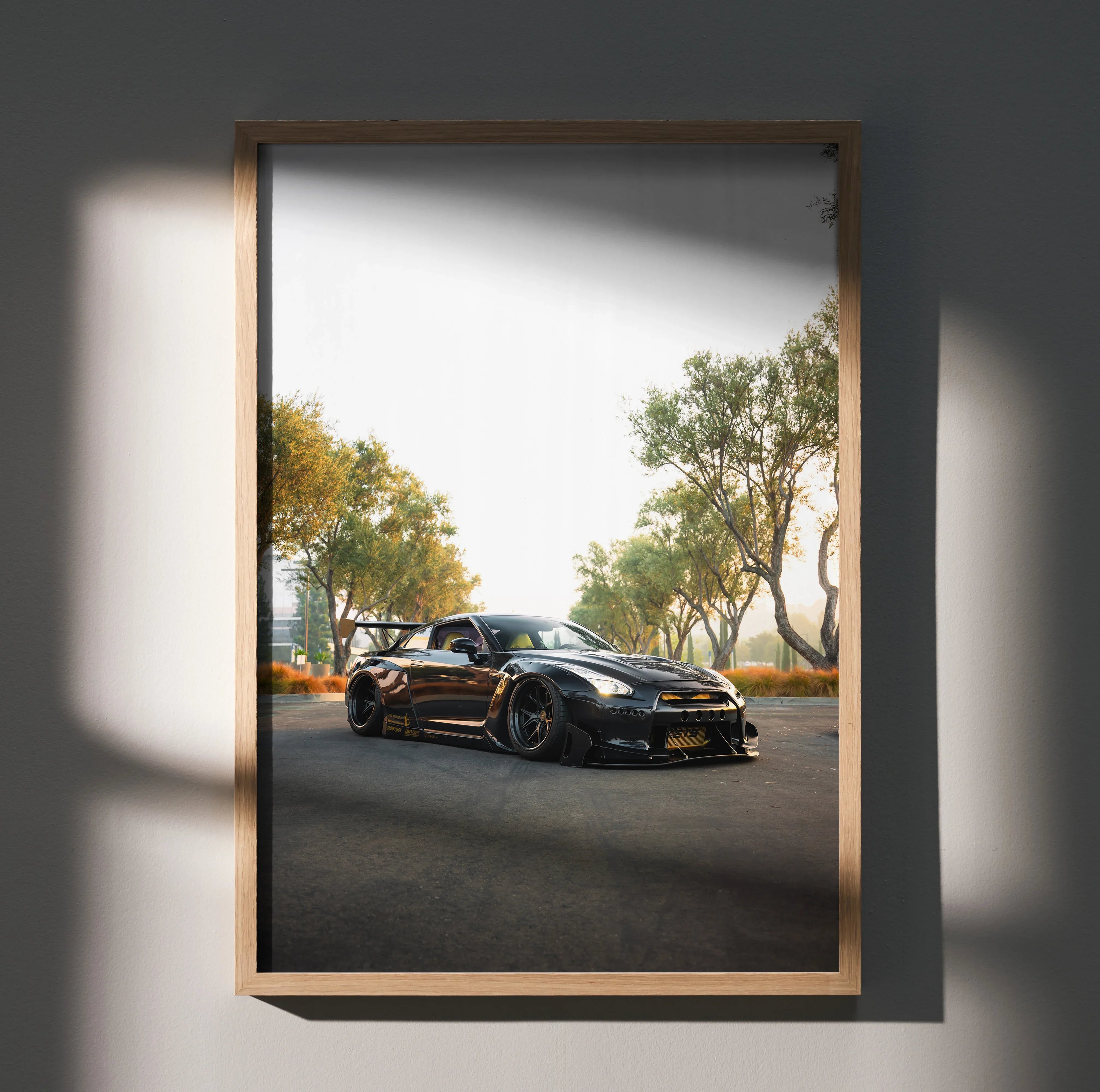 Nissan GT-R R35 black sports car on road at sunset poster wall art in wooden frame.