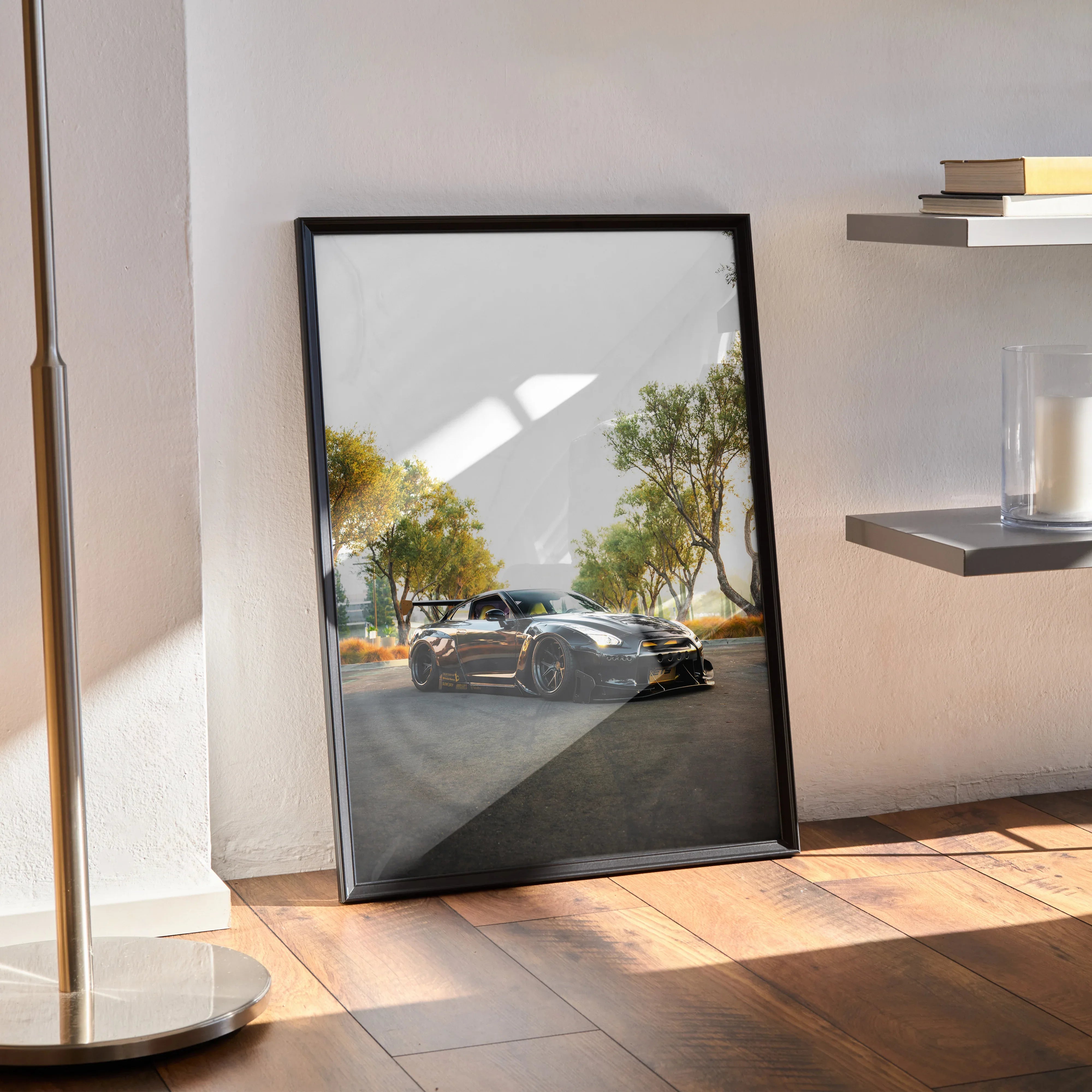 Nissan GT-R R35 poster in black frame leaning on wooden floor with modern wall art decor and natural light shadows.