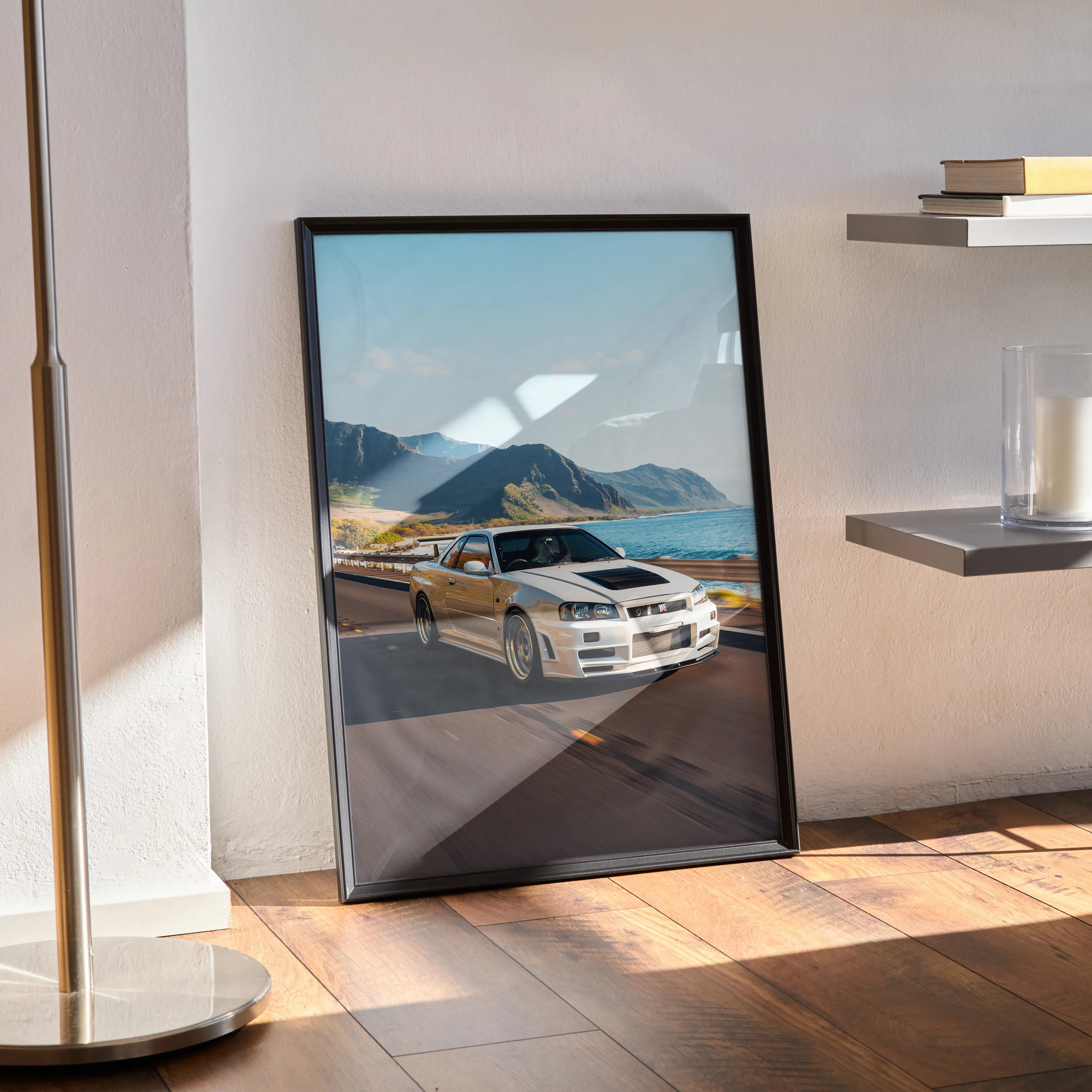Nissan GT-R R34 Skyline poster featuring white car on coastal road, modern wall art in black frame.