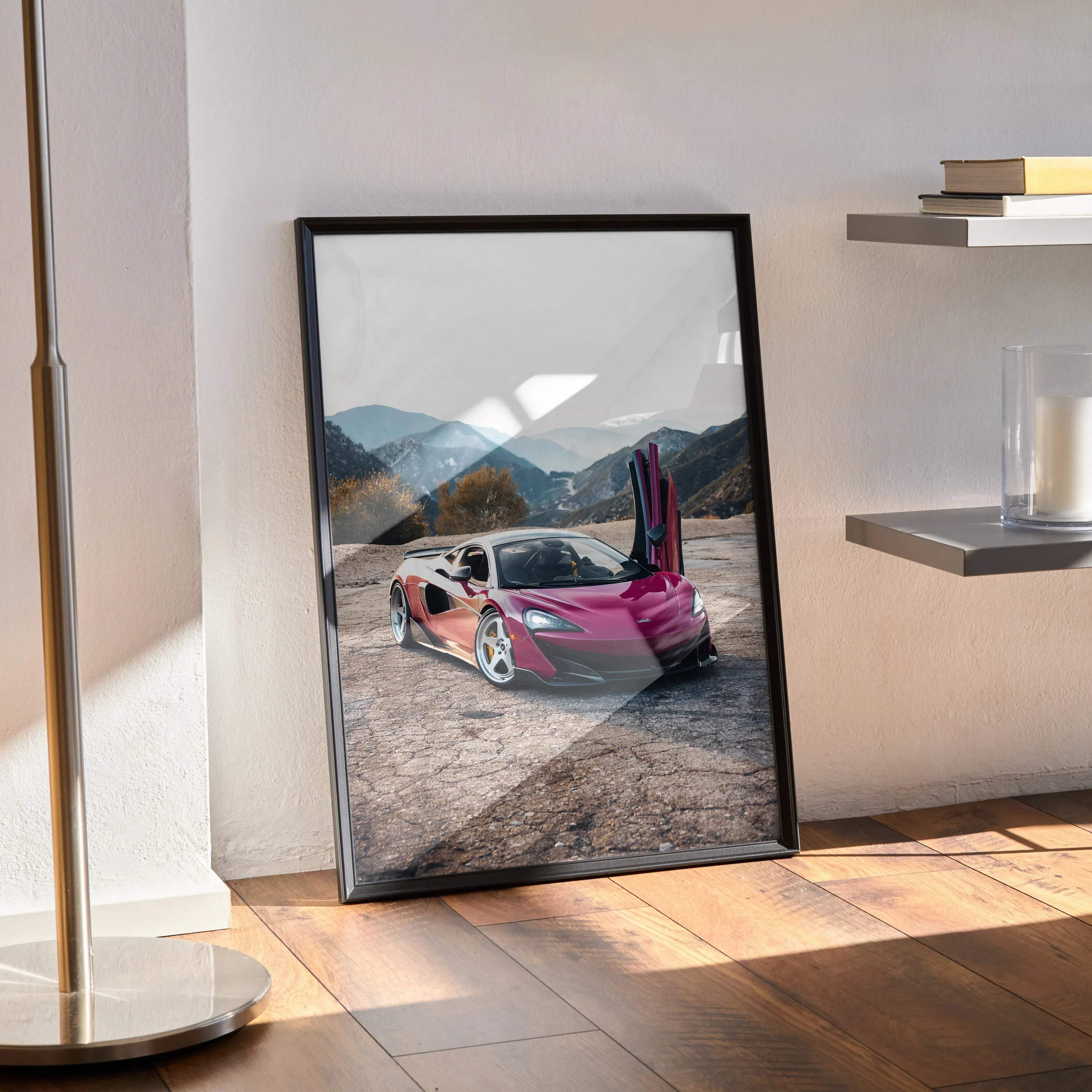 A framed high resolution poster of a vibrant pink McLaren 600LT sports car with open doors against mountains