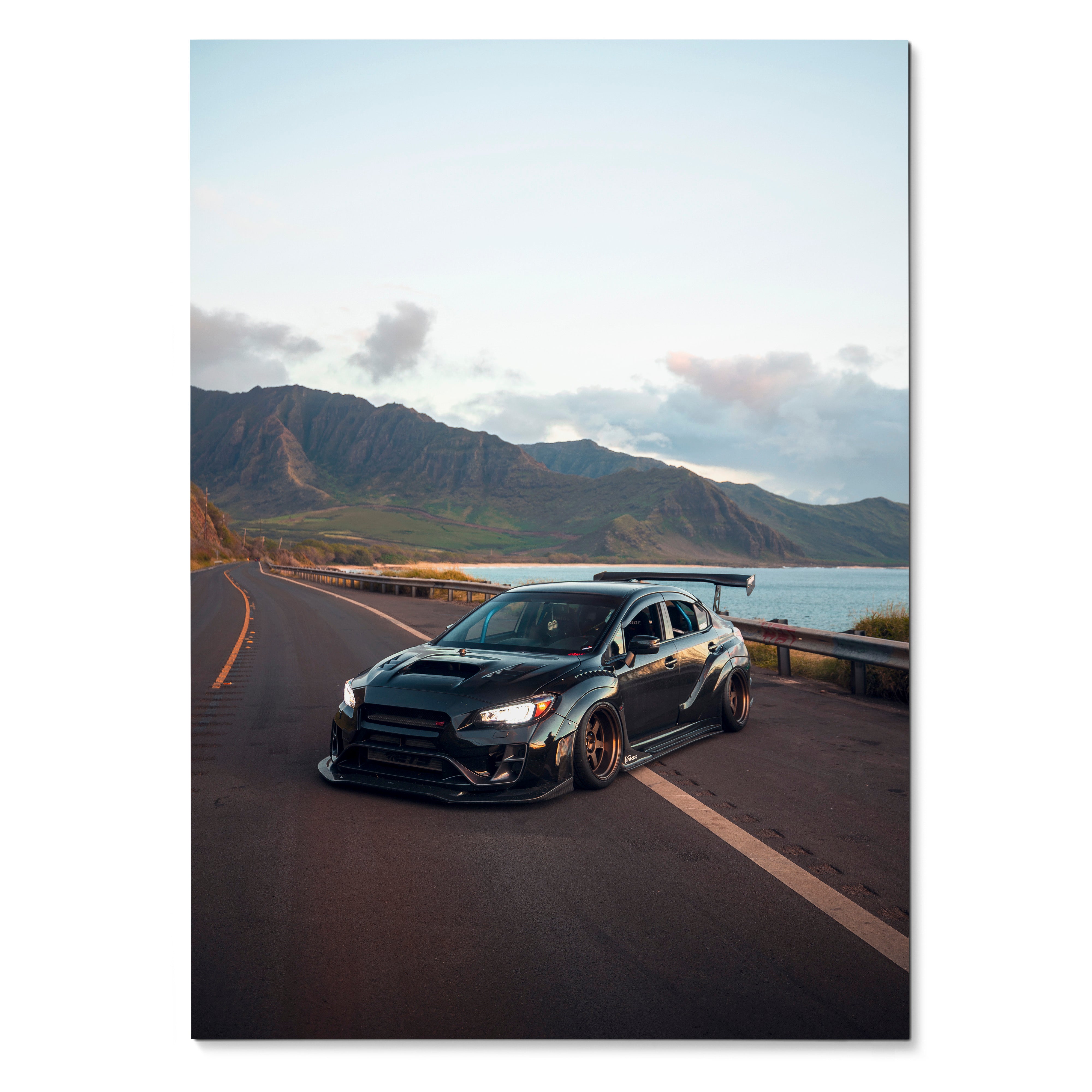 Black Subaru WRX STI parked on coastal road at sunset poster wall art.