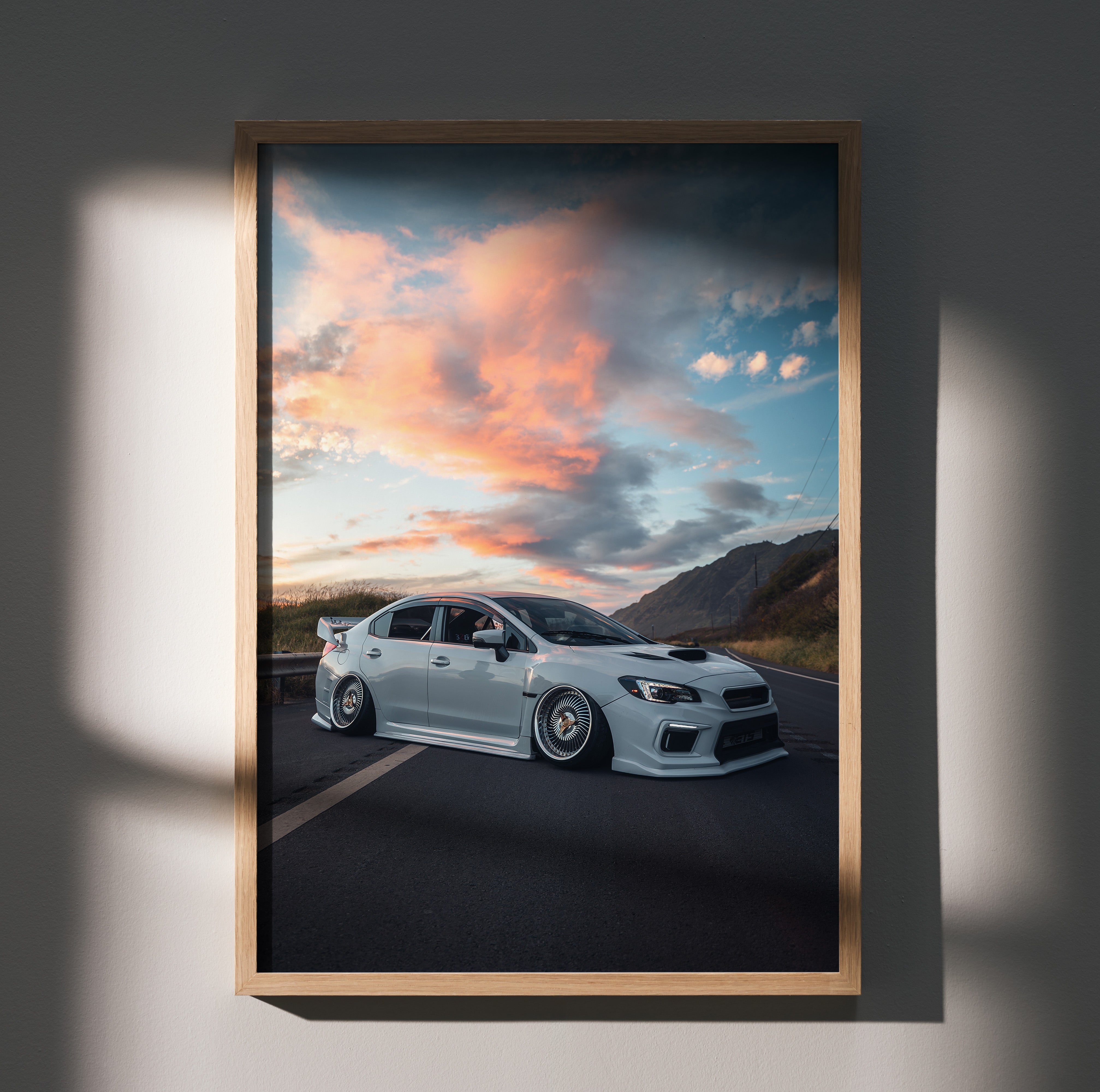 Subaru WRX parked on road with vibrant sunset sky poster wall art.