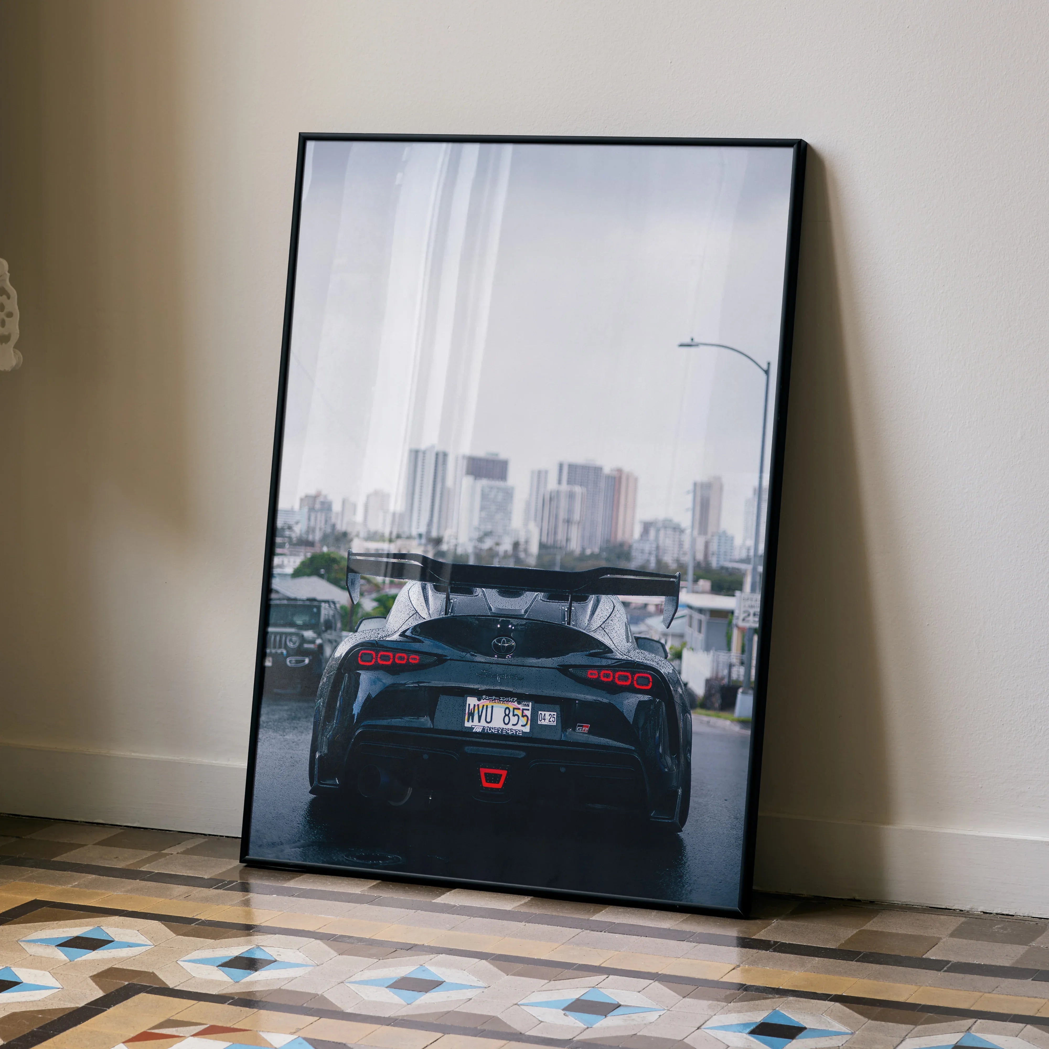 Toyota Supra Mk5 rear view on city road high-resolution poster wall art in black frame.