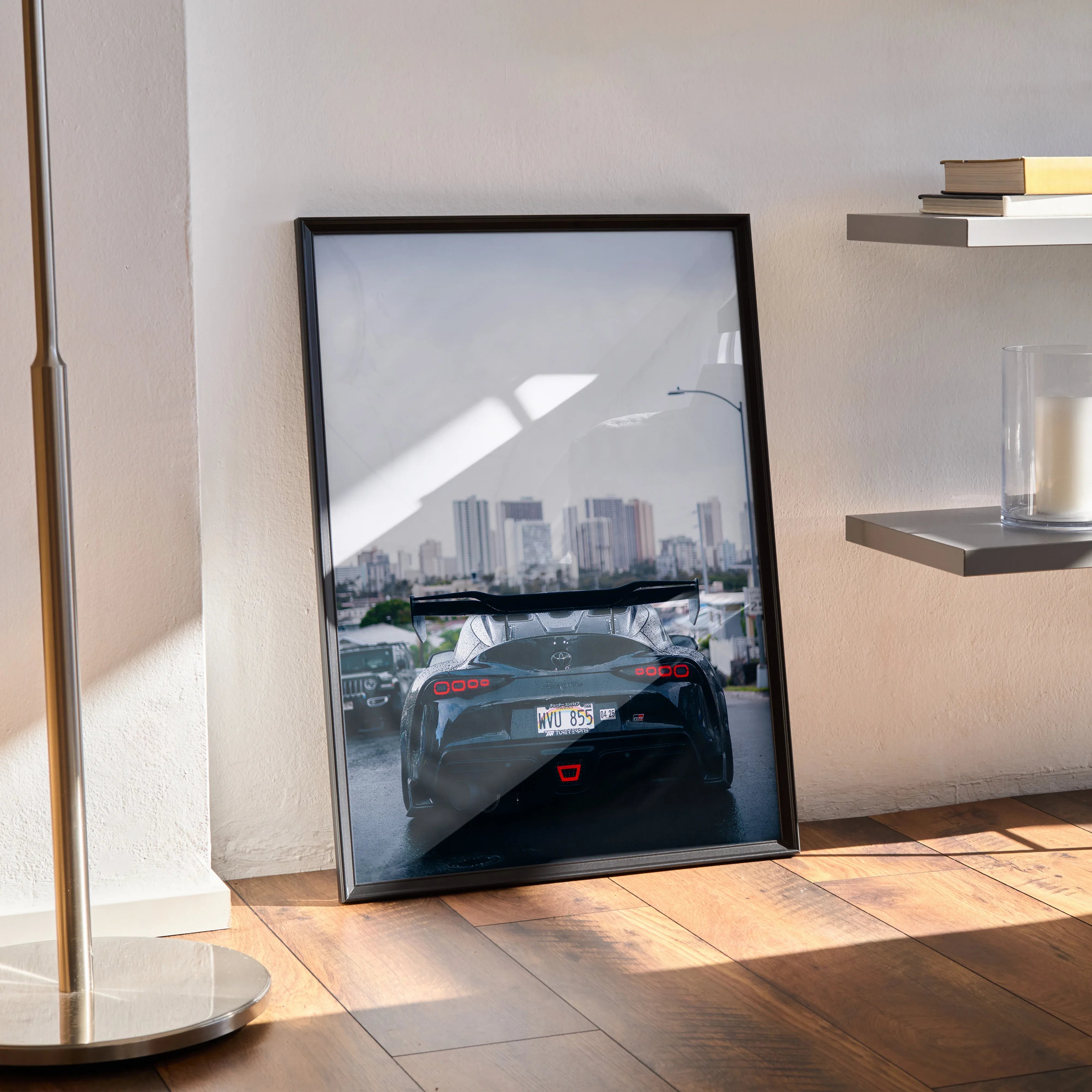 Toyota Supra Mk5 rear view poster leaning against wall with cityscape background wall art.