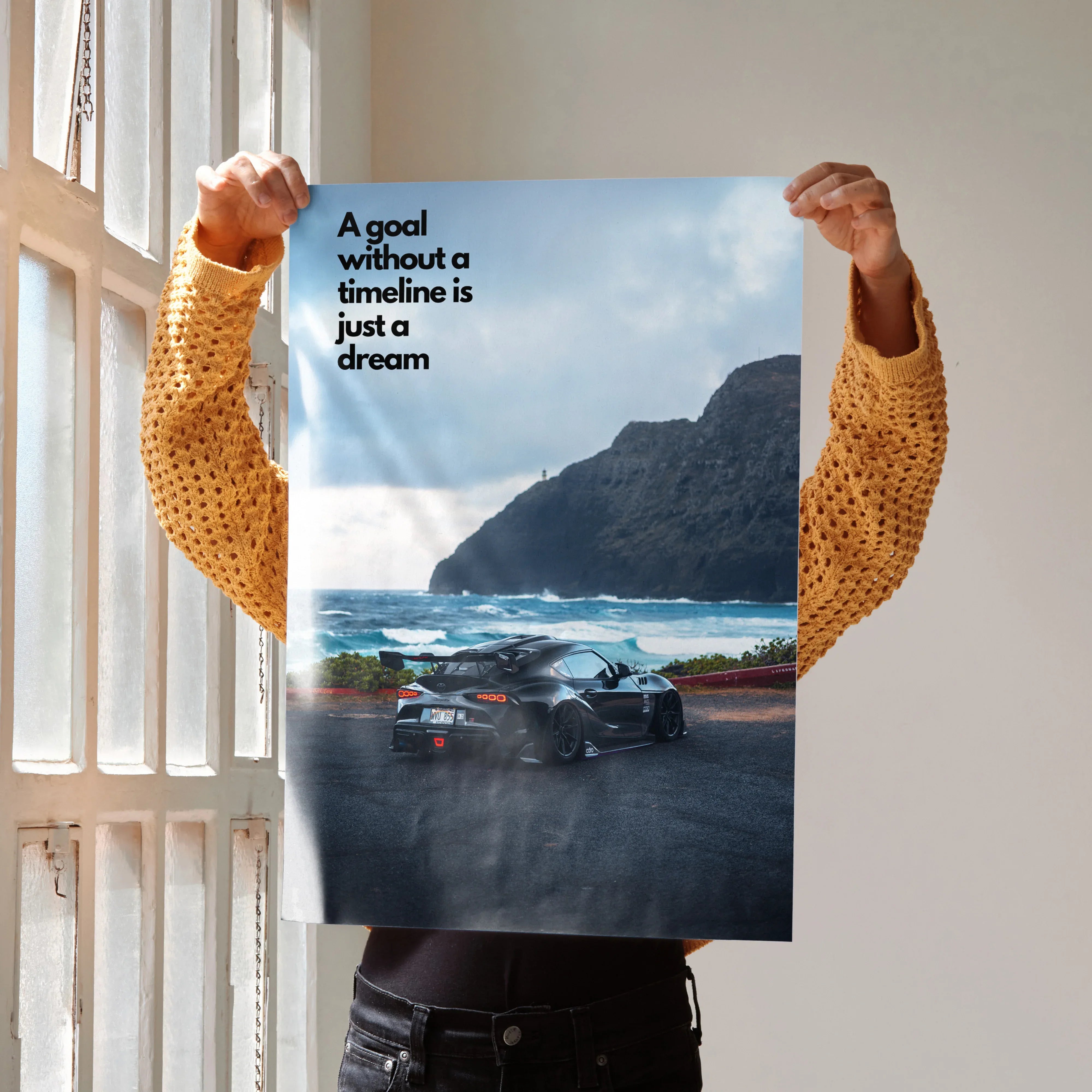 Motivational poster wall art featuring Toyota Supra Mk5 on coastal road with text "A goal without a timeline is just a dream".