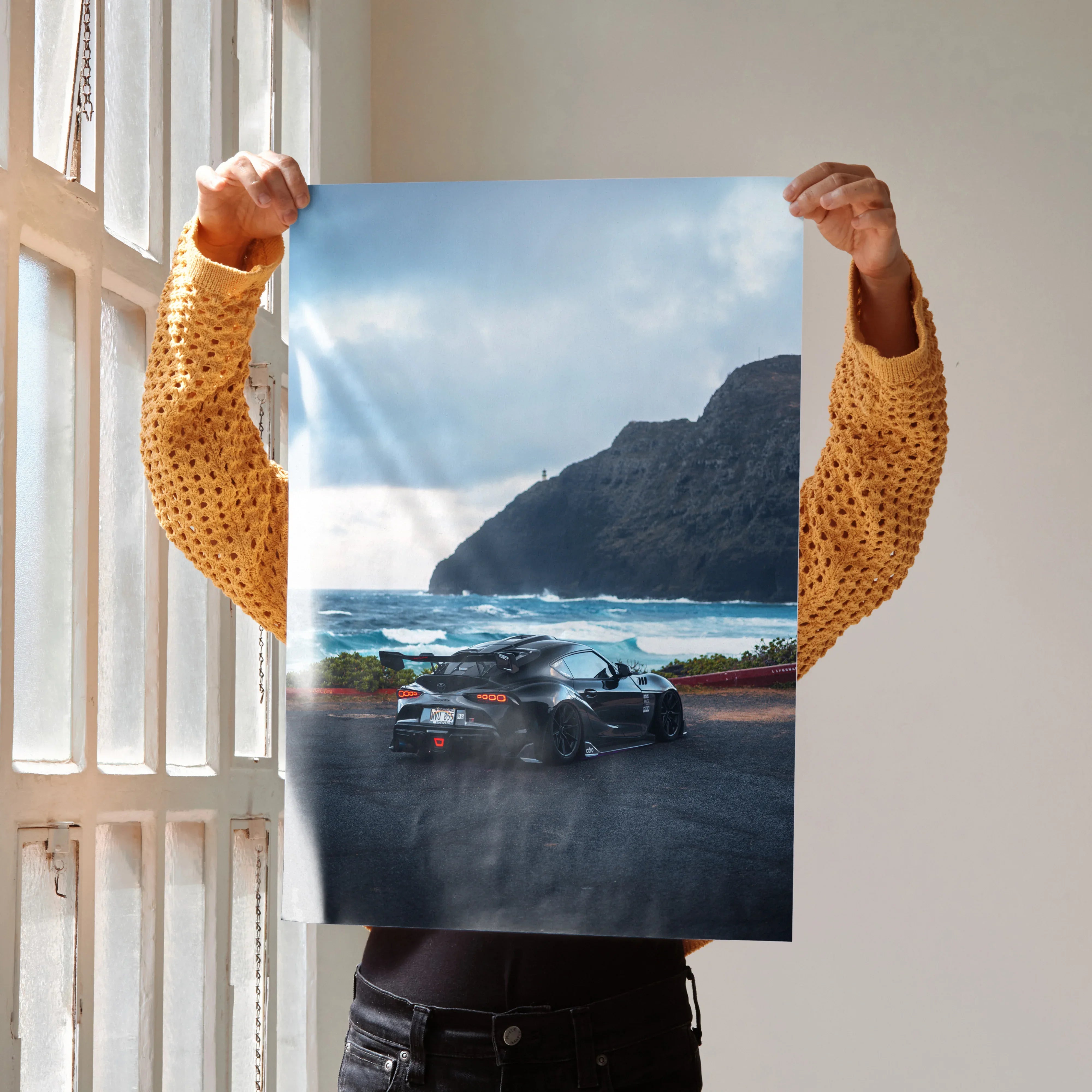 Toyota Supra Mk5 drifting on coastal road with ocean and cliffs backdrop wall art poster.