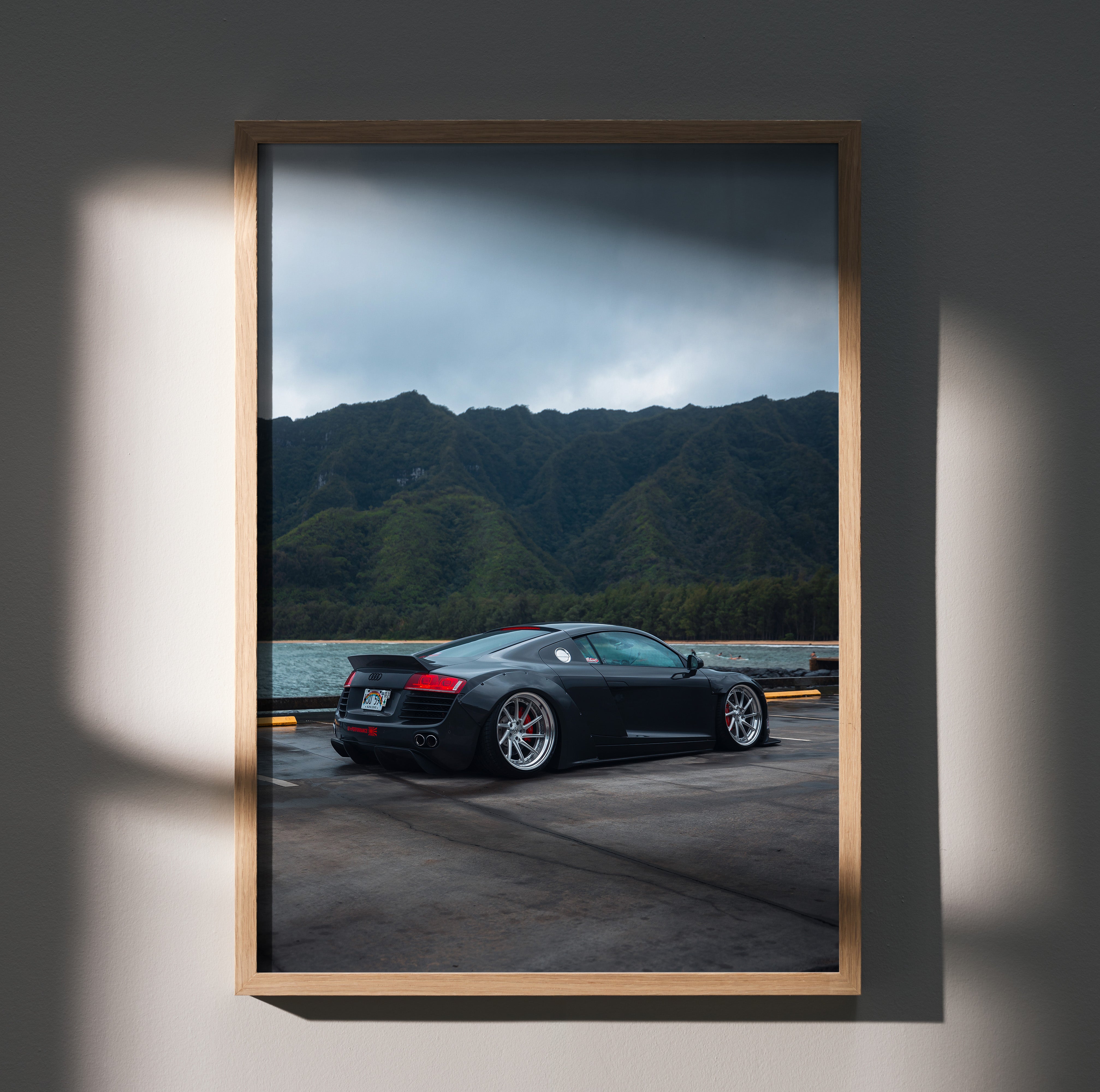 Audi R8 supercar poster wall art with mountain backdrop in sleek black framed print.