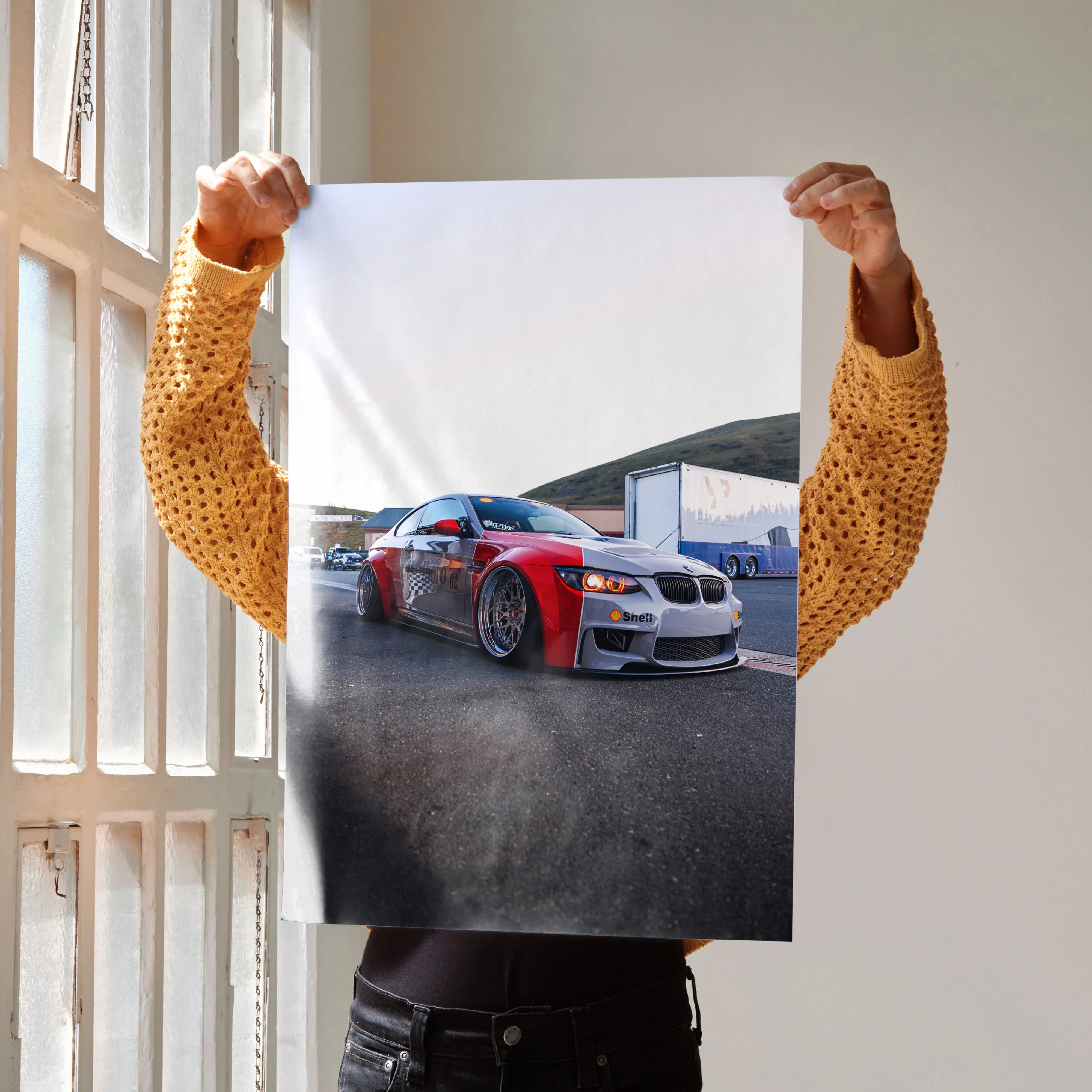 BMW E92 M3 red and white car poster wall art held by person indoors.