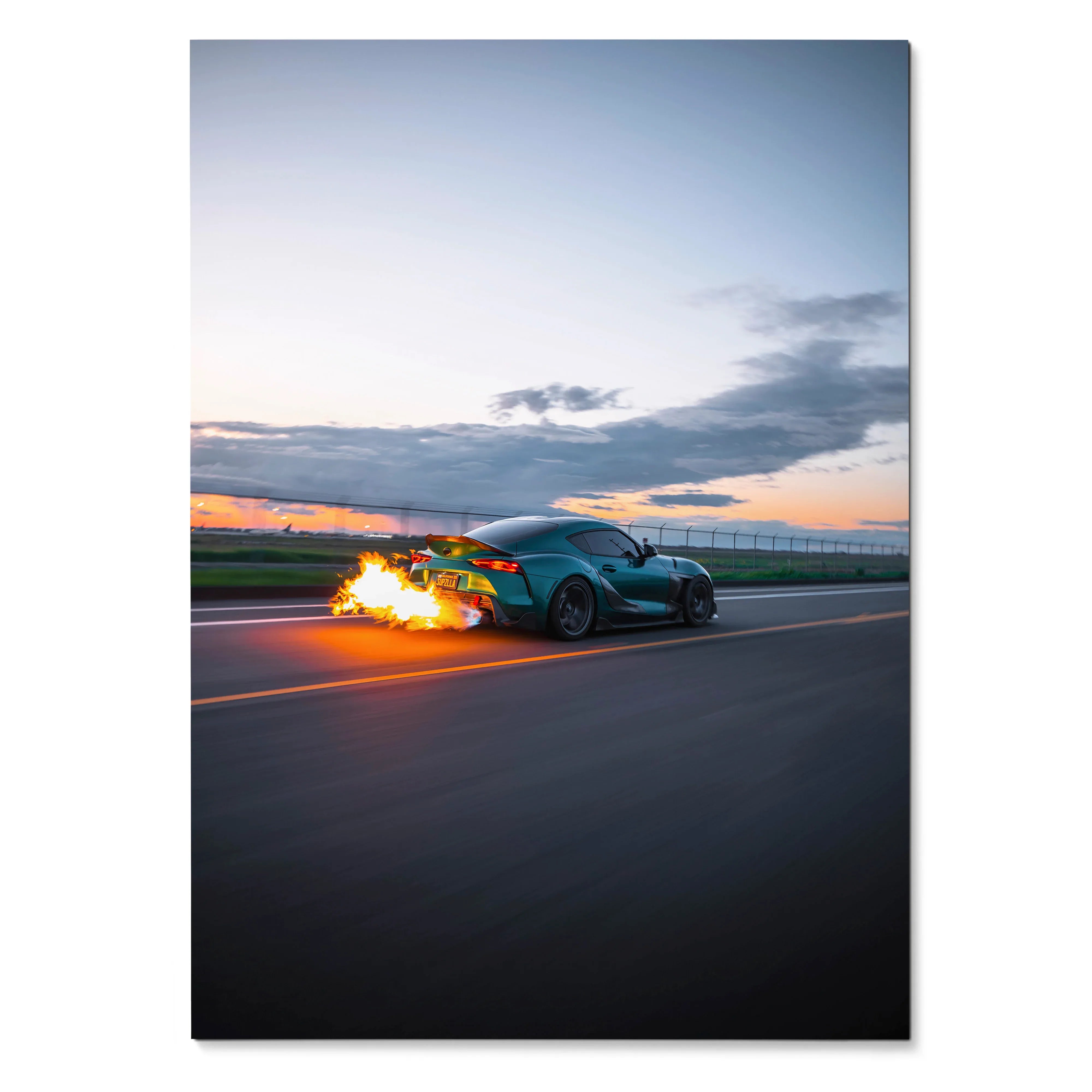 Toyota Supra Mk5 speeding on road with fiery exhaust at sunset poster wall art.