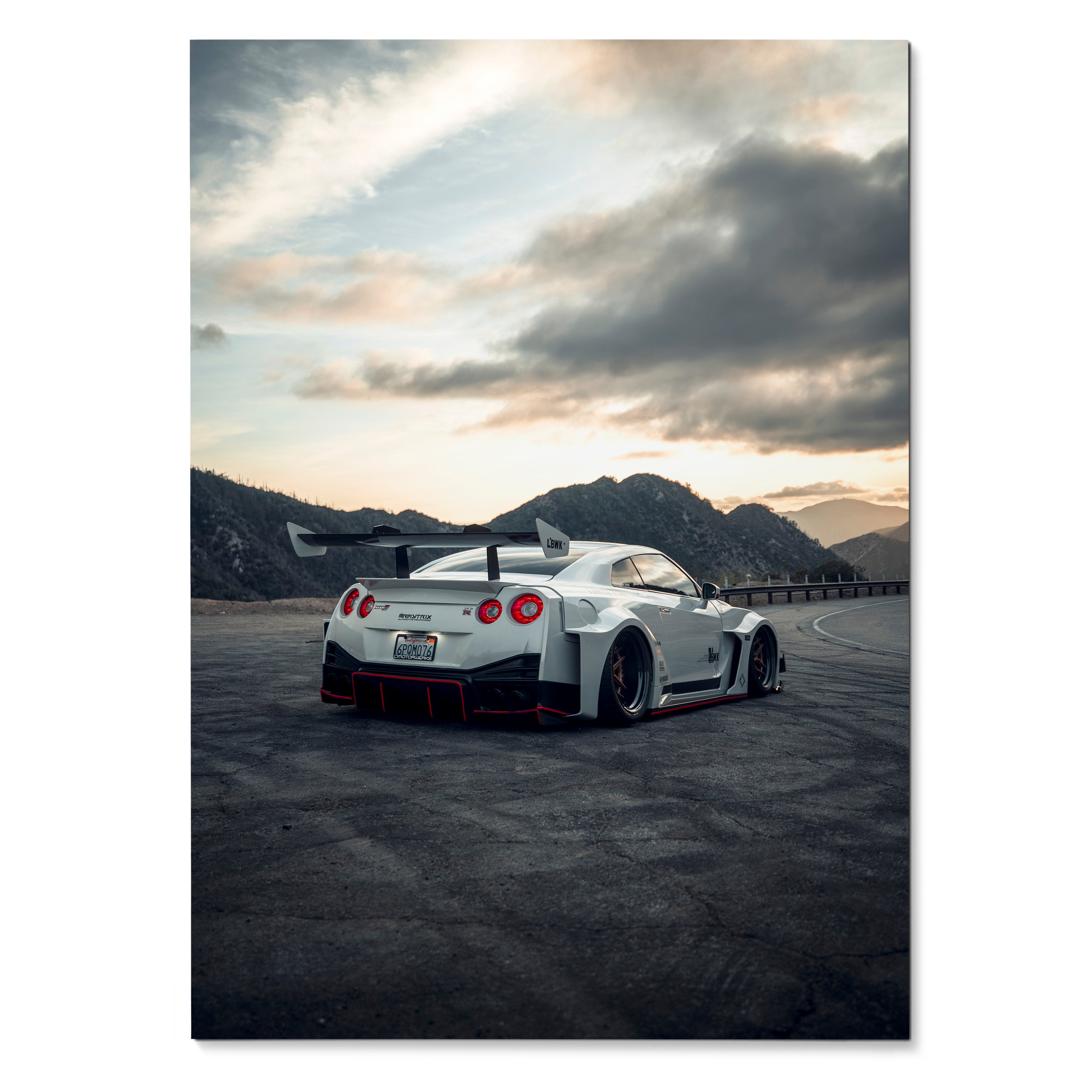 Nissan GTR R35 sports car on open road at sunset poster wall art with dramatic sky.