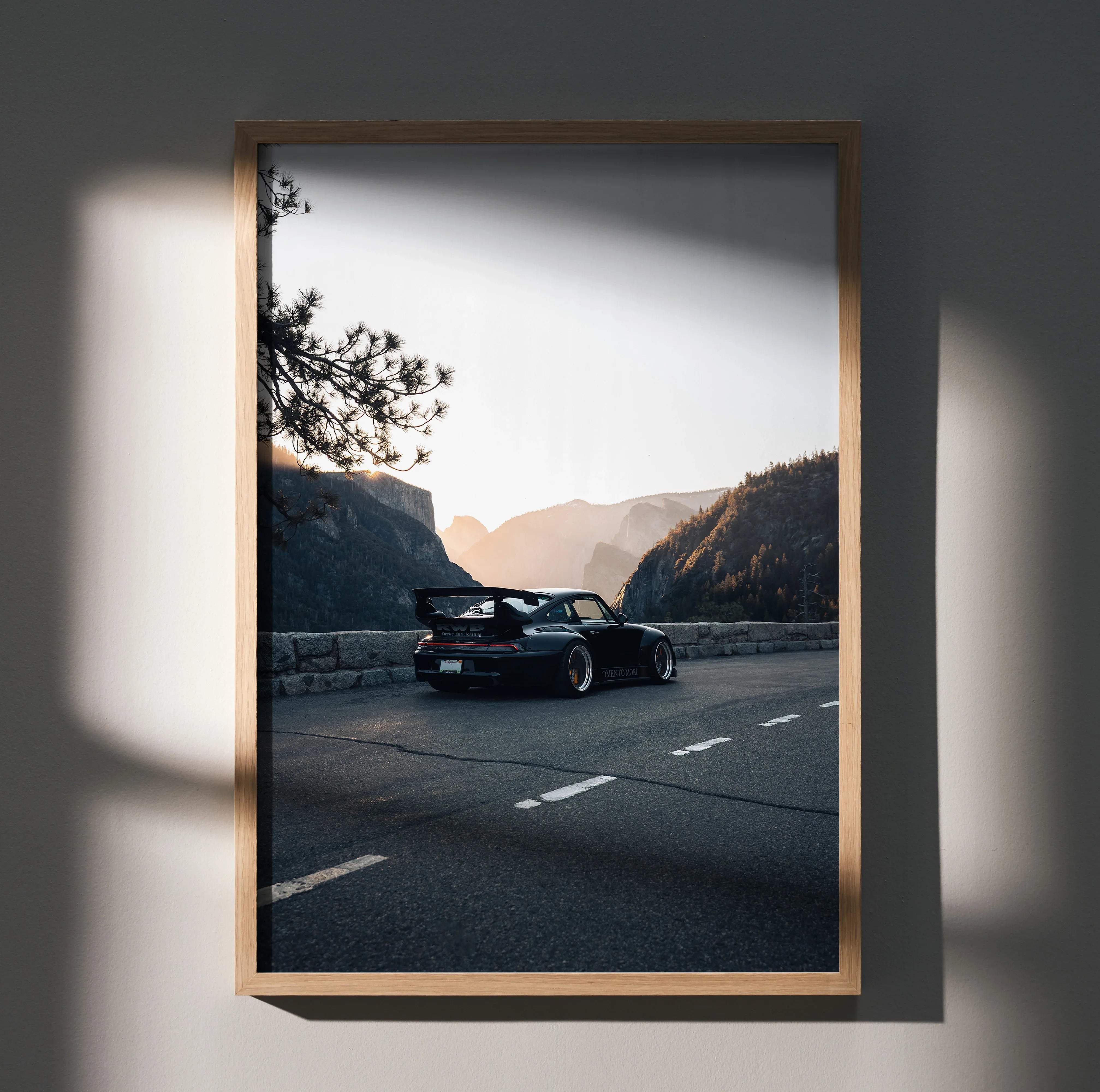 Black porsche 911 wall art poster with rear spoiler in matte finish framed in minimalist light wood for automotive decor