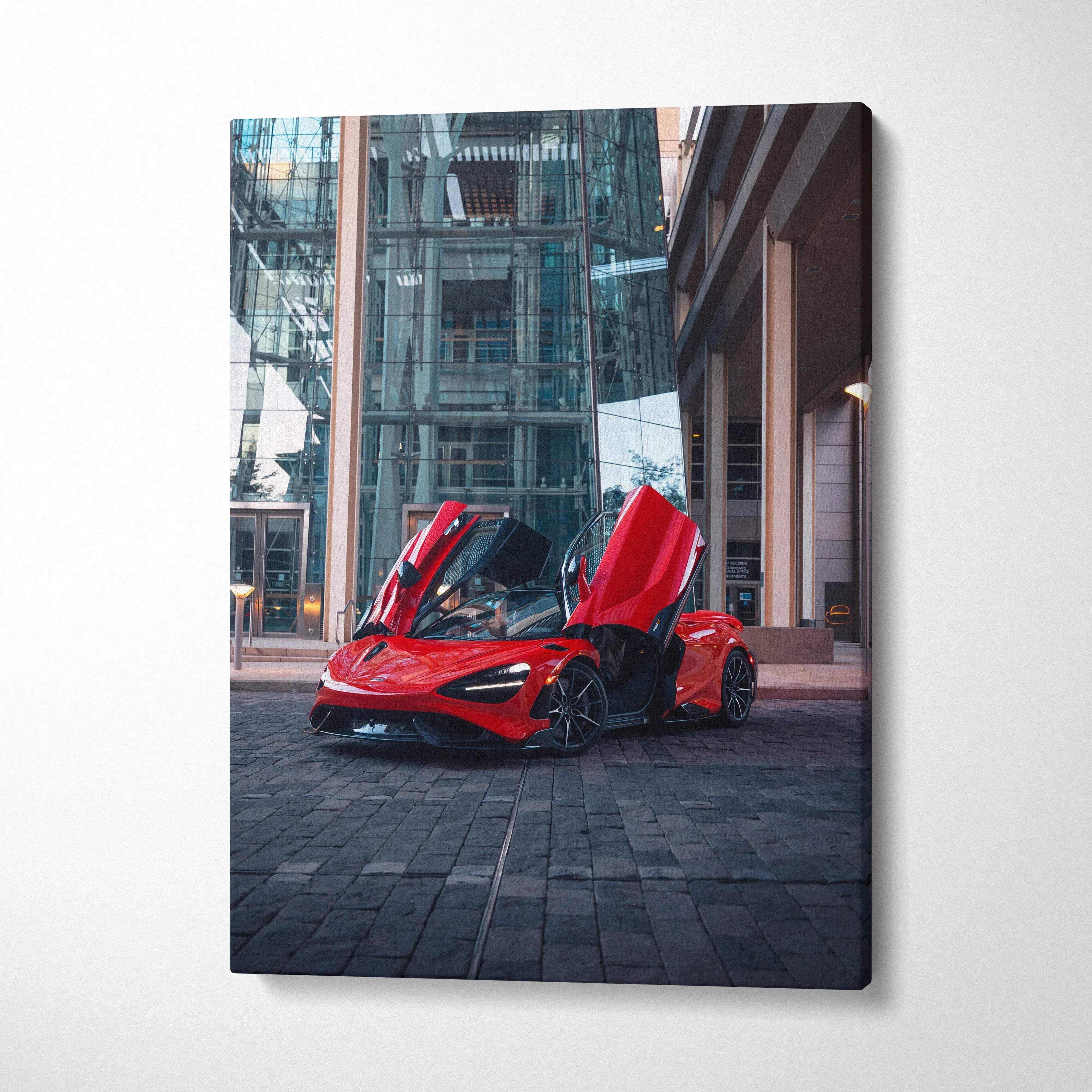 Canvas wall art vertical car print of a red mclaren 765lt with gull-wing doors open in front of a modern glass building