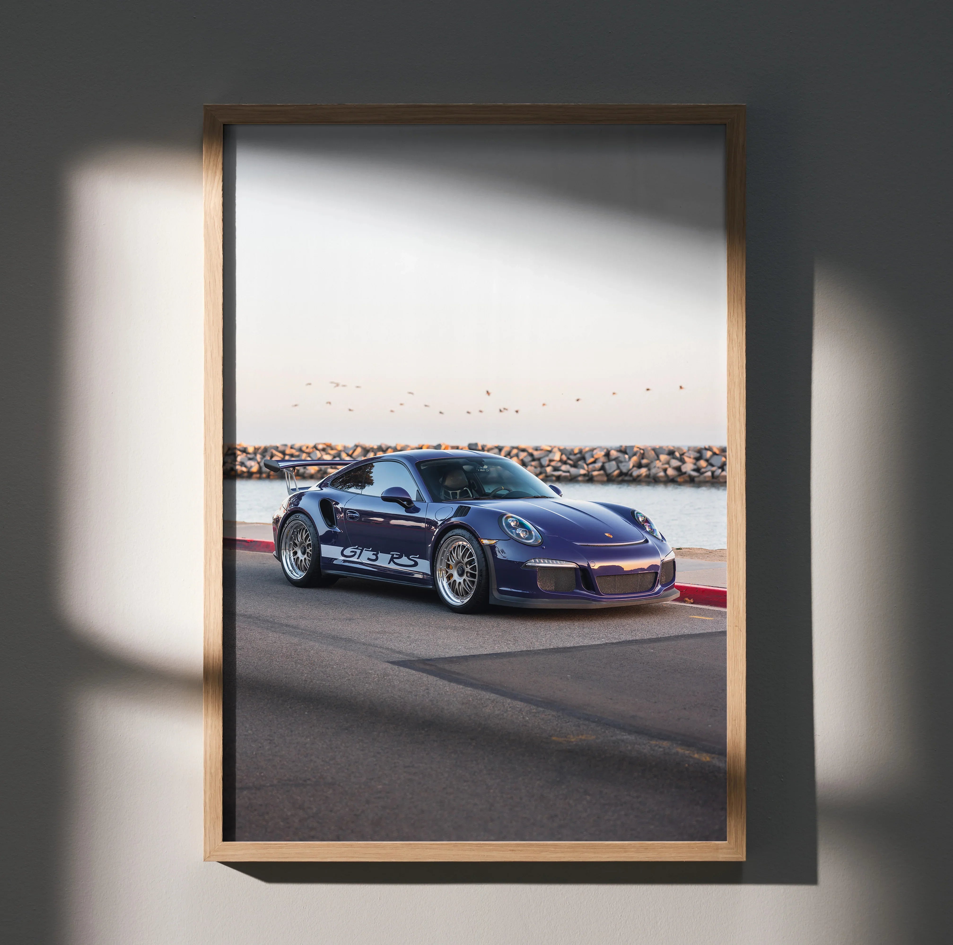 Porsche 911 GT3 RS parked by waterfront on wall art poster in wooden frame.