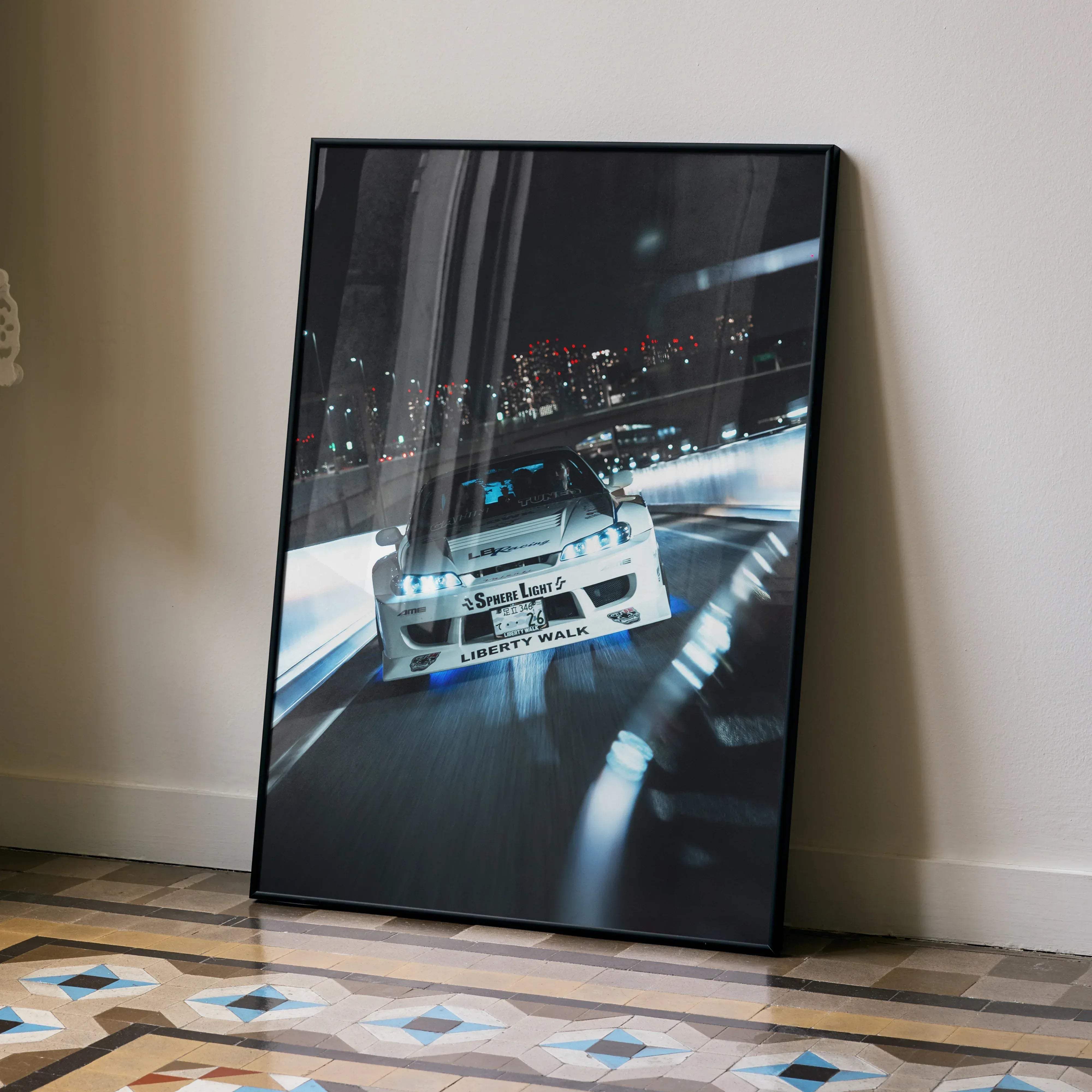 Black-framed poster of a white nissan silvia s15 drift car with blue underglow and liberty walk branding in motion at night