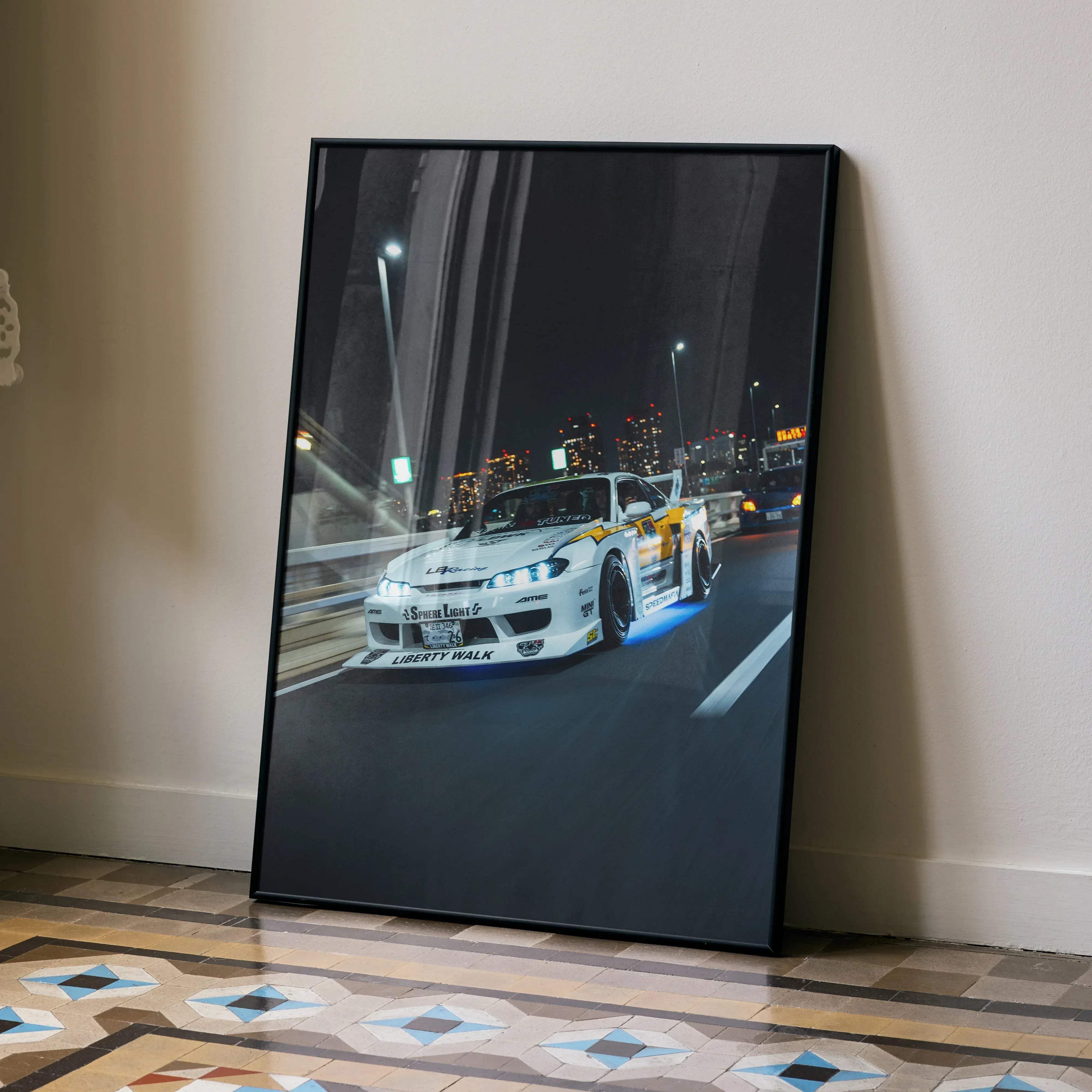 Black-framed canvas print of white and yellow nissan silvia s15 drift car with blue underglow speeding through cityscape