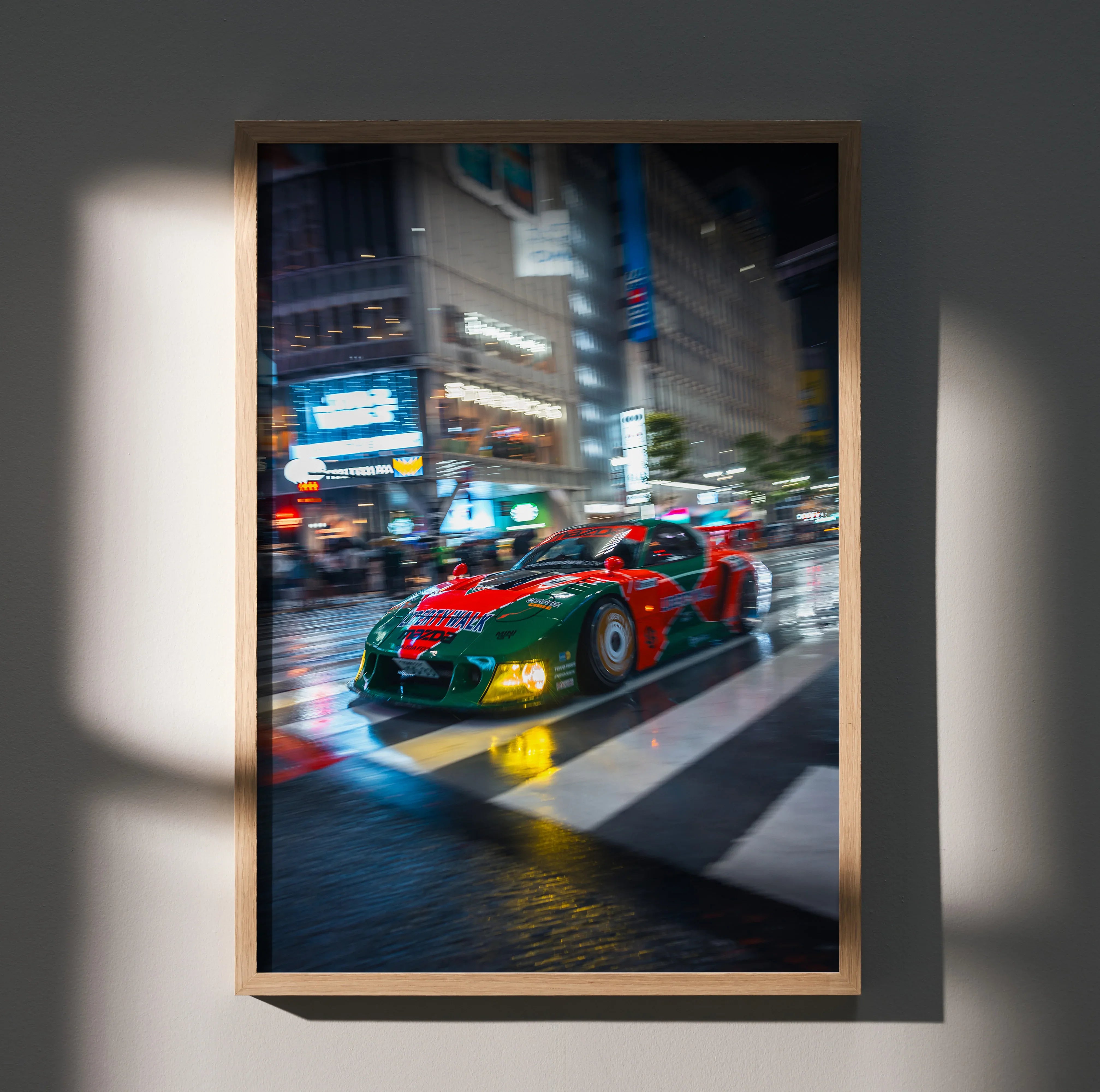 Mazda FD RX7 in red and green with yellow wheels racing on city street at night poster wall art.