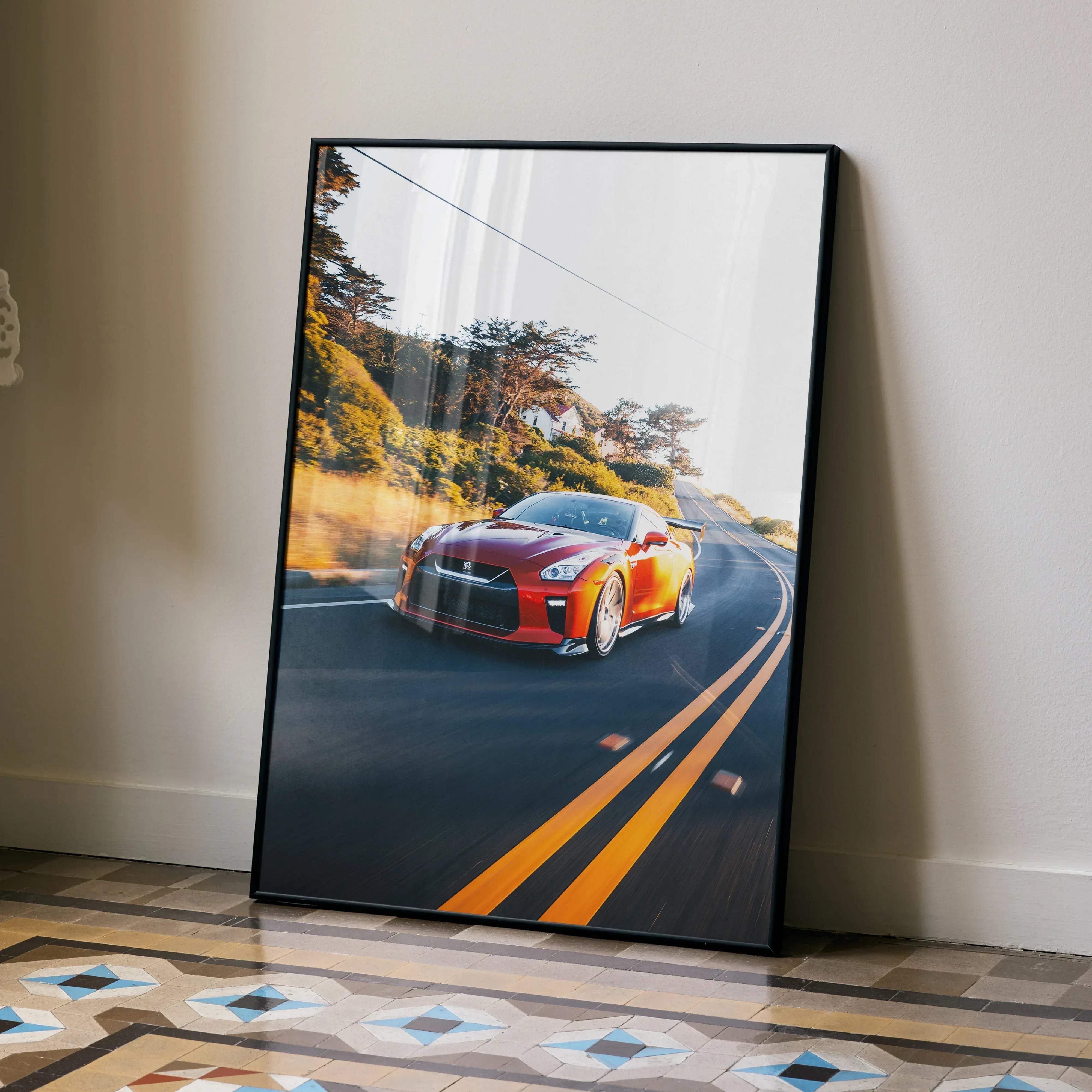 A framed premium art print of a vibrant red Nissan R35 GT-R speeding on a winding road for car enthusiasts