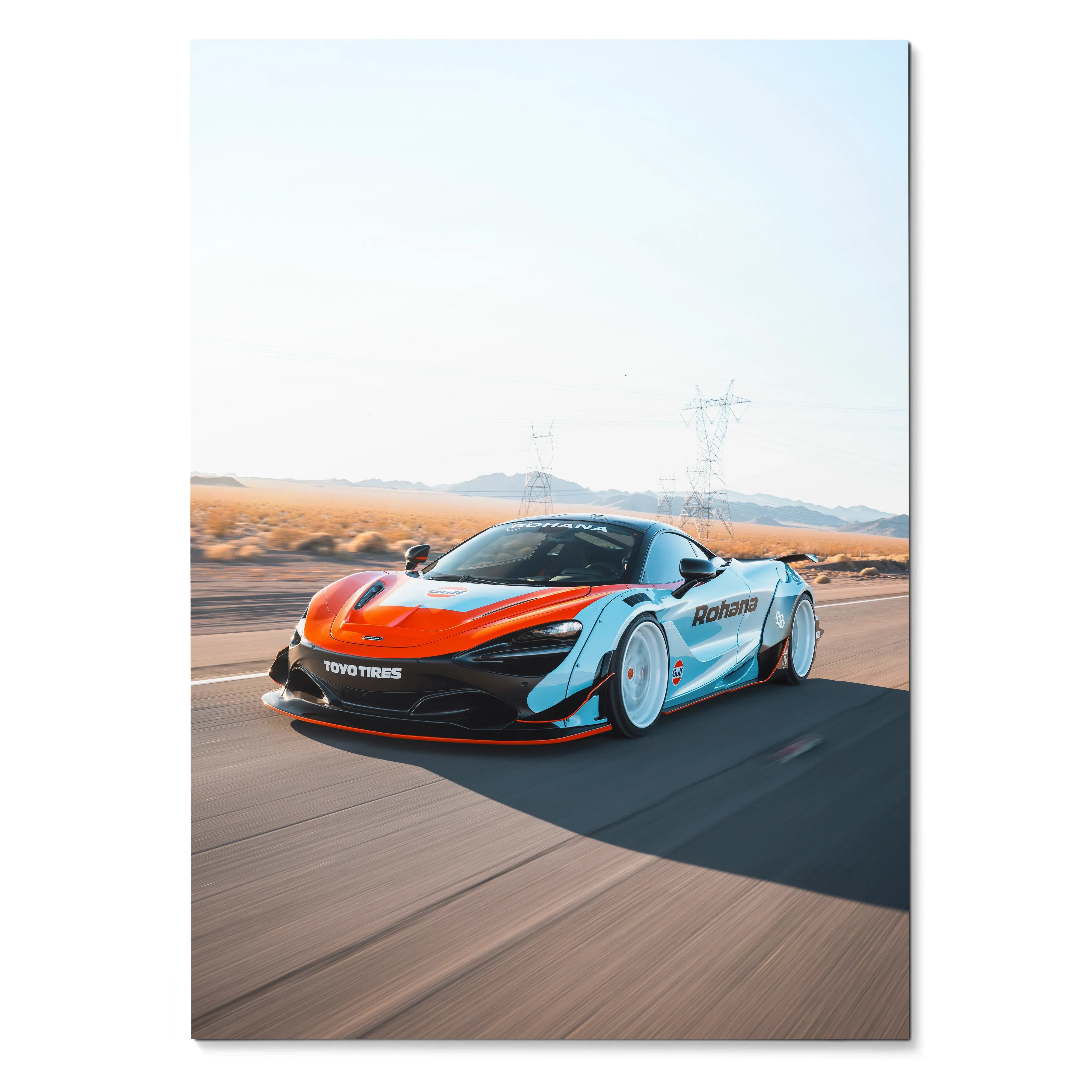 McLaren 720S supercar driving on desert road poster wall art with clear blue sky.
