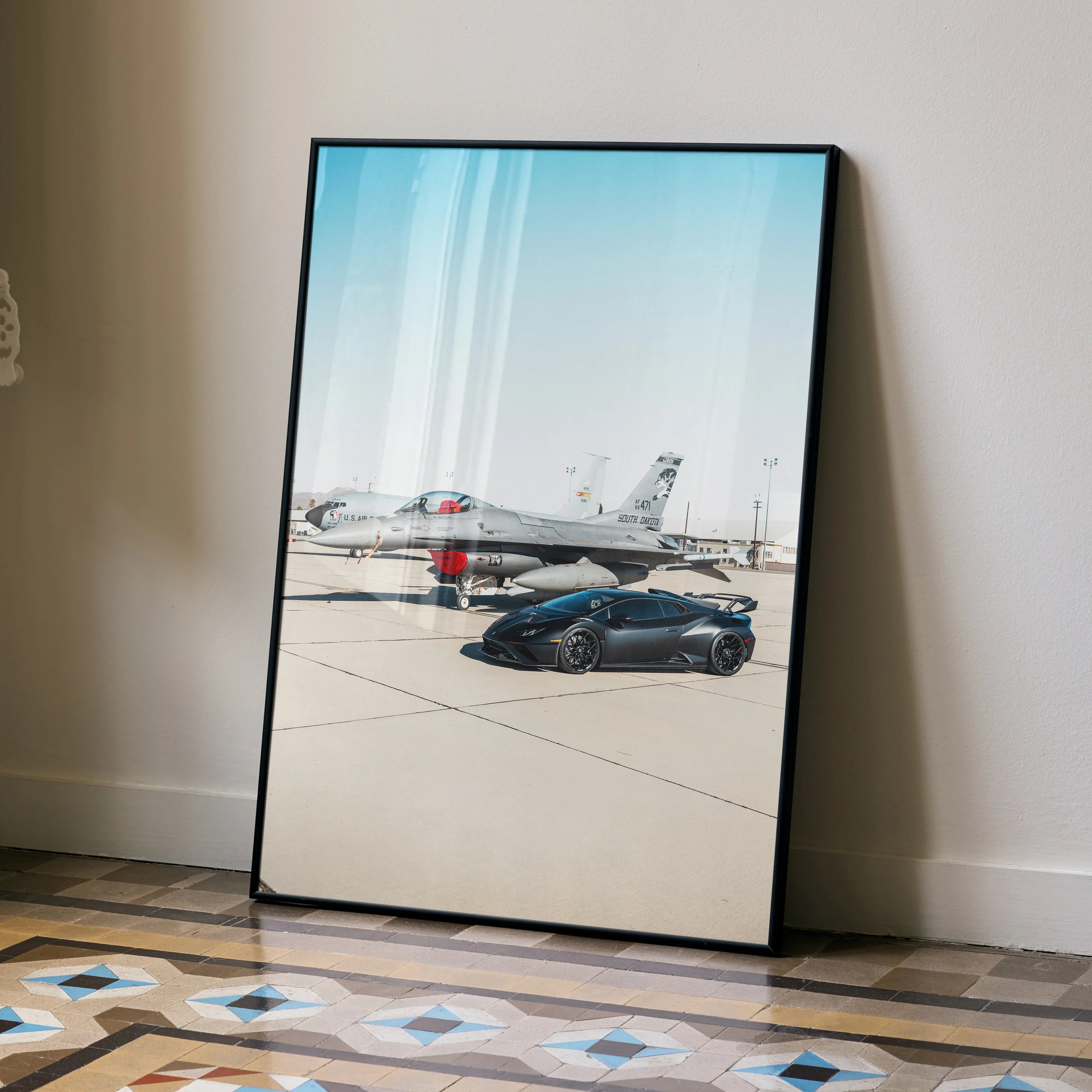 Lamborghini Huracan STO poster with black frame displayed on floor, luxury automotive wall art.