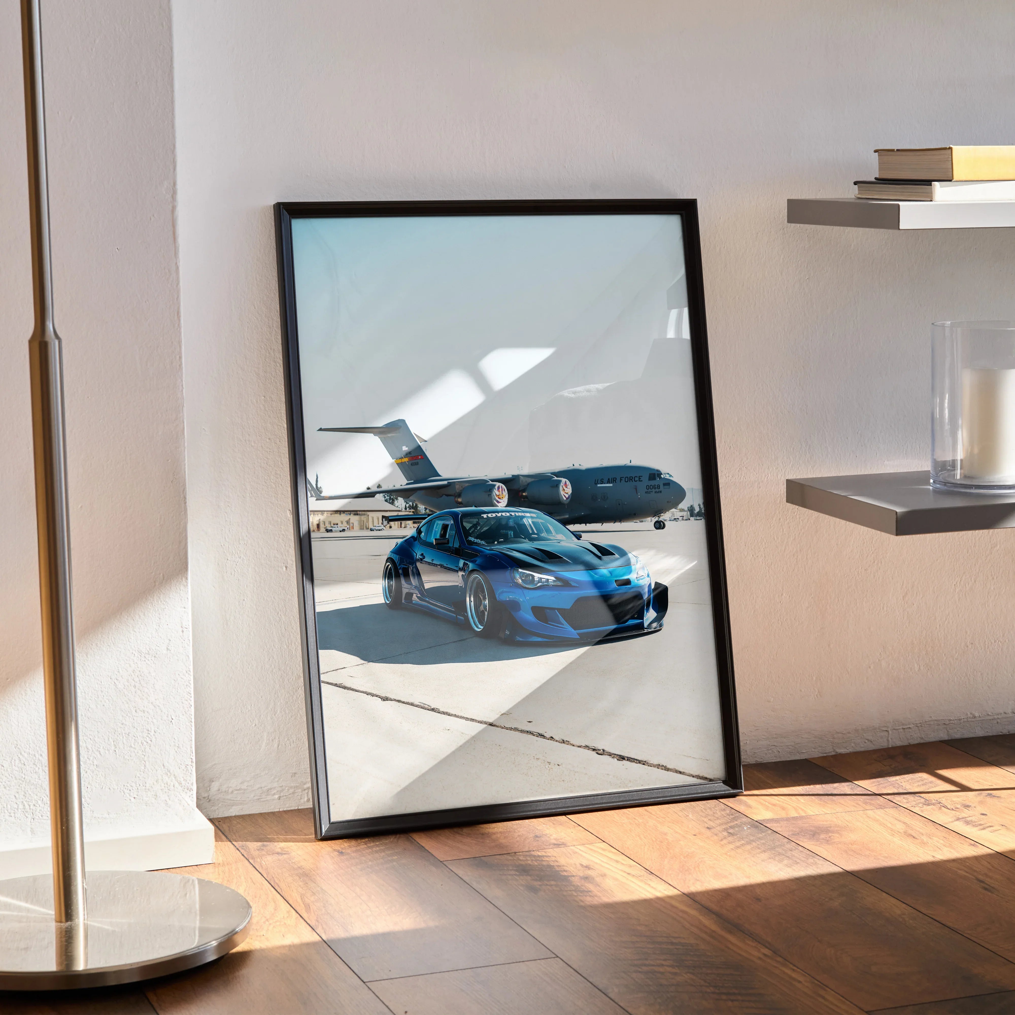 Sleek blue widebody Toyota FRS car poster with reflections in black frame leaning on floor wall art decor.